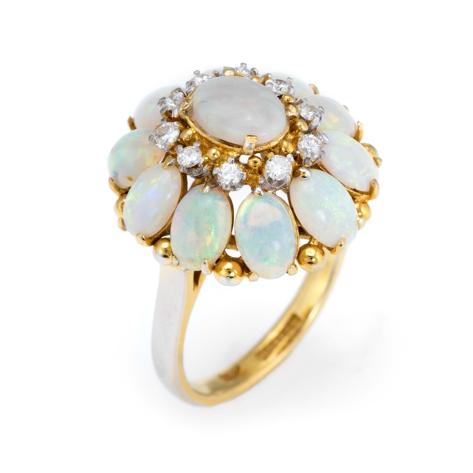 Finely detailed vintage H Stern opal & diamond cocktail ring (circa 1960s to 1970s), crafted in 18 karat yellow gold. 

10 natural opals measure 6mm x 4mm (estimated at 0.50 carats each). the center set opal measures 7mm x 5mm (estimated at 0.75