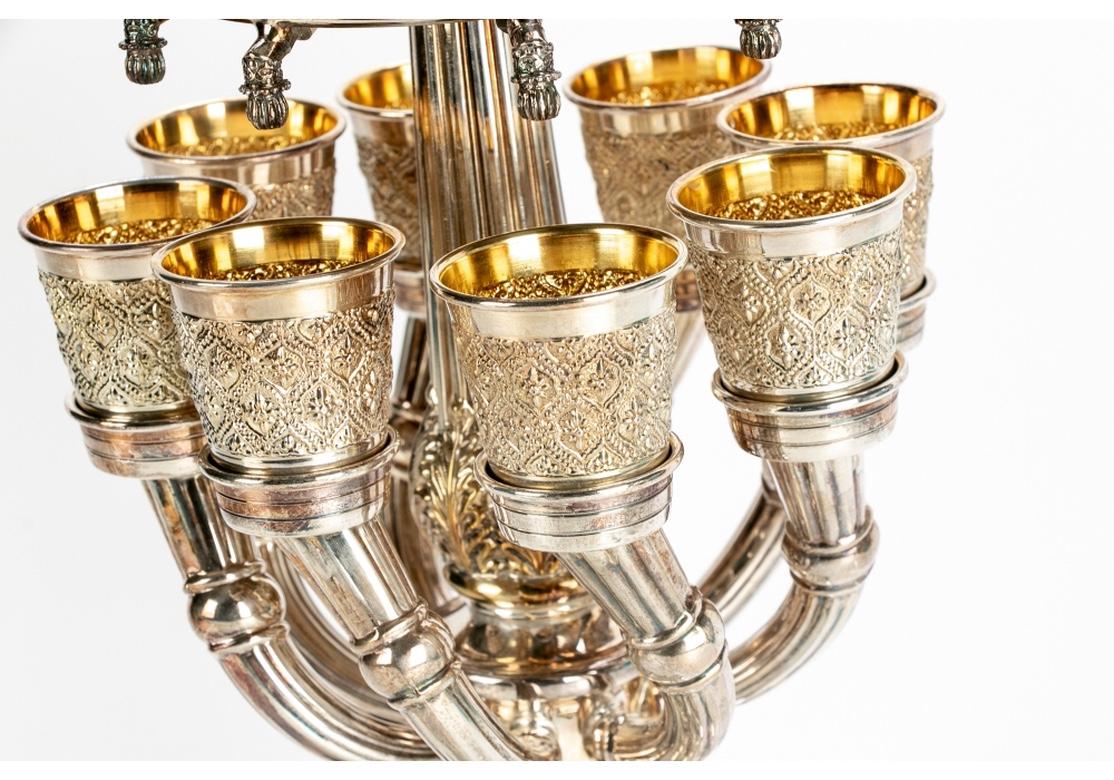 Vintage sterling silver Kiddush wine fountain with fountain having a star and beaded relief design, fluted standard with eight emitting stands for the vermeil cups, one kiddish cup atop, fluted and egg/dart design and resting on four well cast