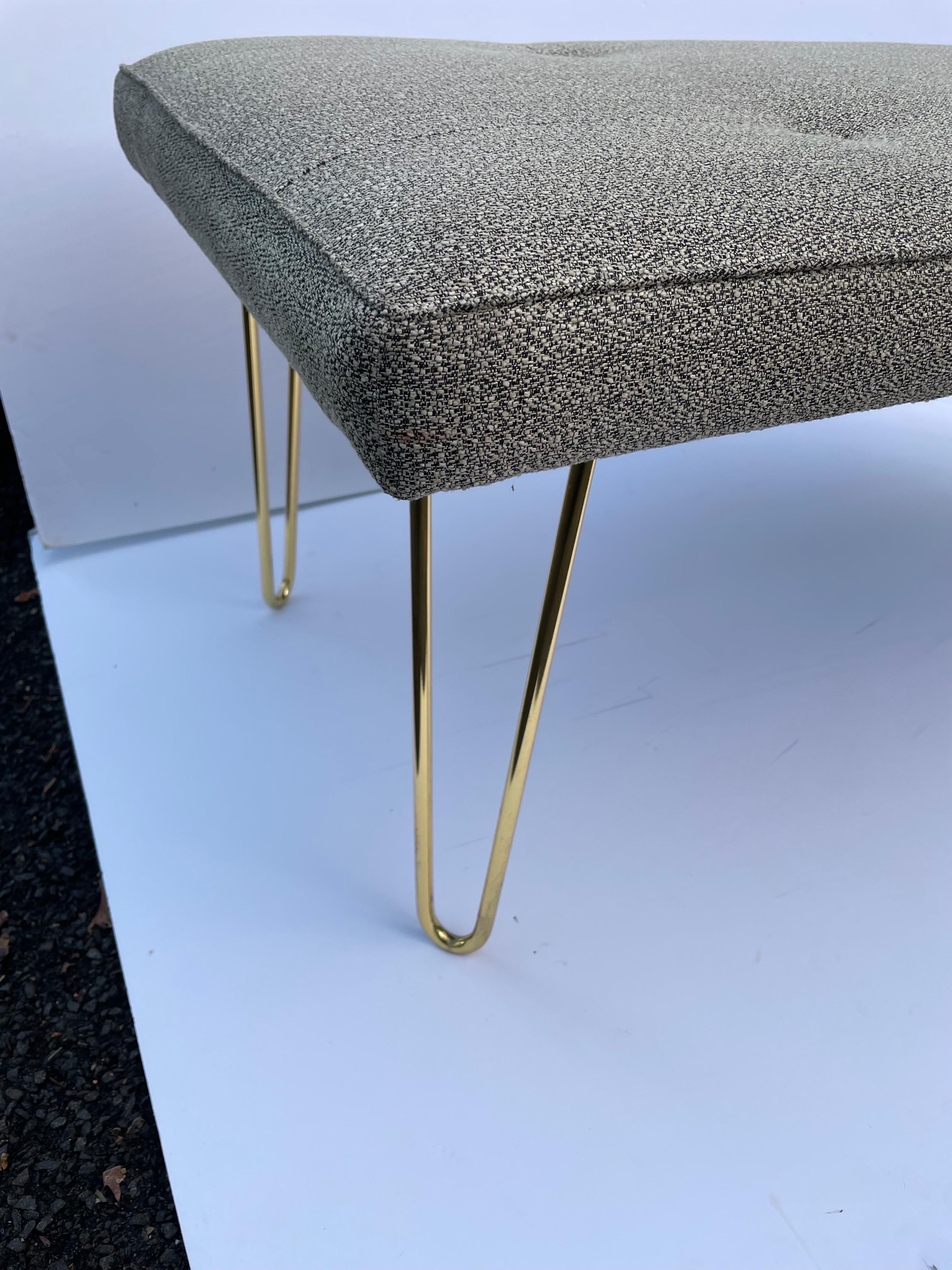 Vintage Mid-Century Modern style upholstered bench with brass plated hairpin shaped legs and newly upholstered seat with four buttons, seaming, and welting top and bottom. 48