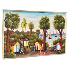 Peinture vintage d'art naïf haïtien représentant un paysage de village côtier, réalisée par Jacky Salomon