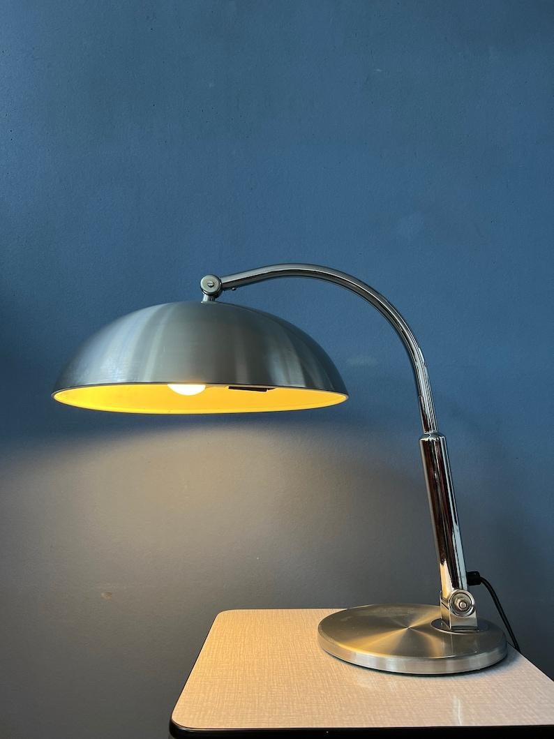 Silver bauhaus table lamp classic 'Hala Busquet' or 'Hala 144' designed by Herman Busquet for Hala Zeist. The shade can be moved up and down as well as the tripod, which can move up and down. The lamp does not use its original switch anymore, there