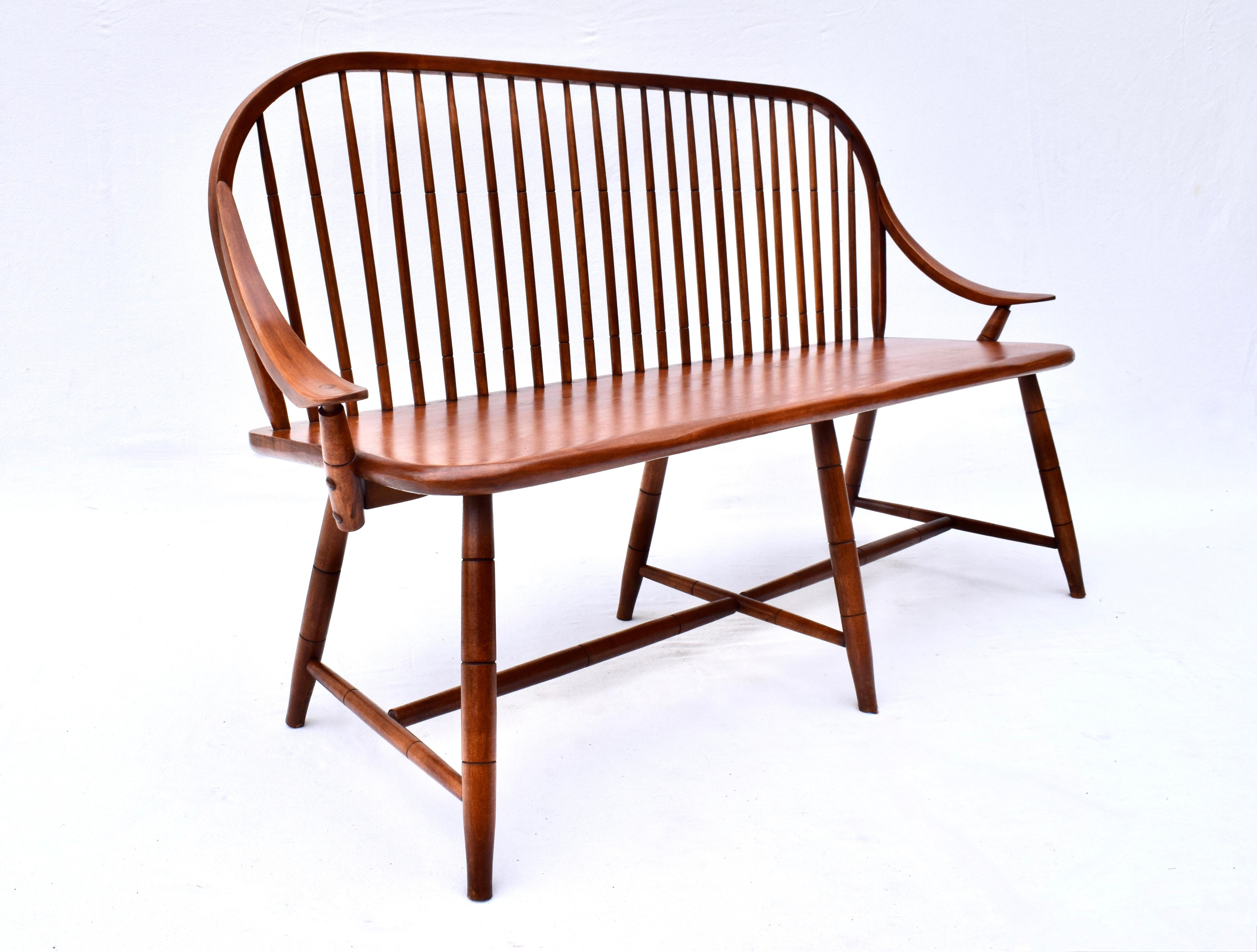 Hale of Vermont continuous bow & swag arm Windsor spindle back bench with full stretcher constructed of solid Maple. Generous proportions, refinished in solid clean condition. Circa 1970.
