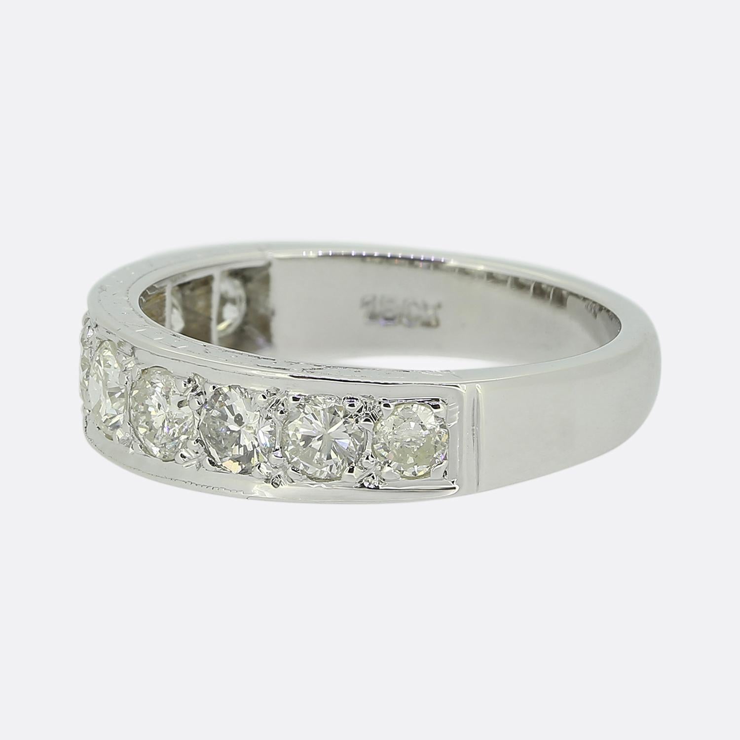Here we have a lovely half-eternity diamond ring crafted from polished 18ct white gold. This vintage piece features a series of round brilliant-cut diamonds, each meticulously claw set to enhance their natural sparkle. The diamonds are arranged in a