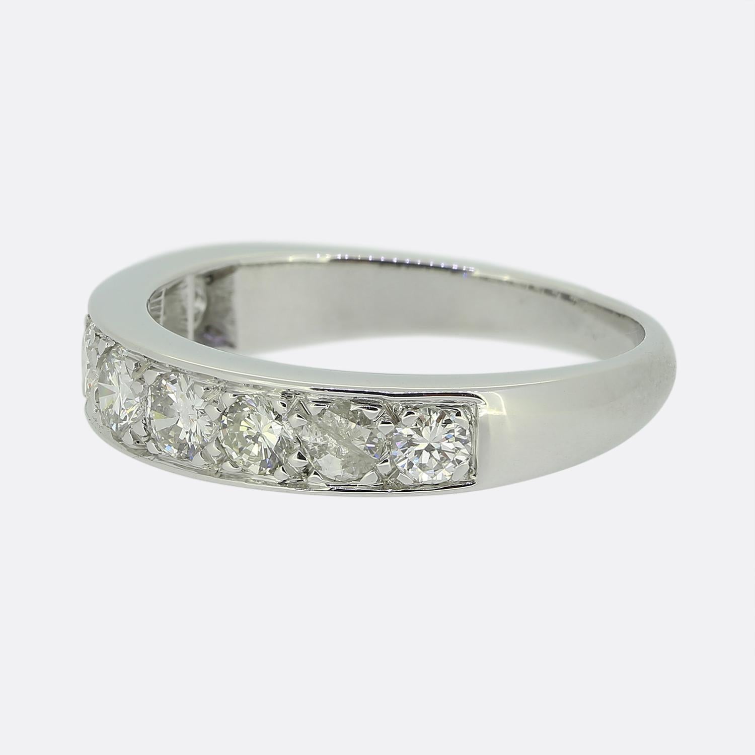Here we have a stunning diamond ring featuring a sleek band crafted from luxurious 18ct white gold. The design showcases a single row of white round brilliant-cut diamonds, each of which has been individually claw set to enhance their sparkle and