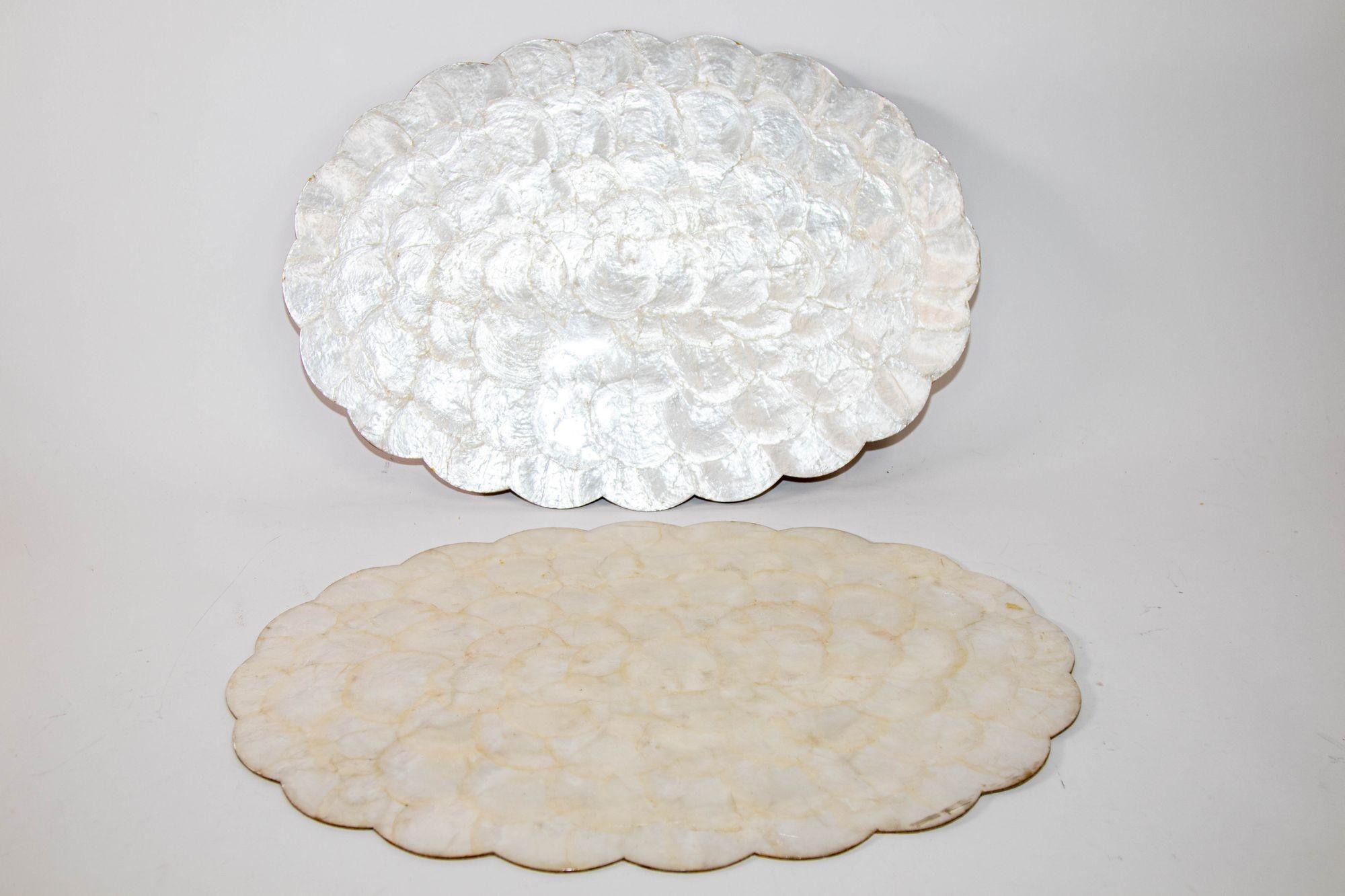 Vintage Hallie St Mary placemats, set of two capiz, abalone, pearl shell design scalloped edge oval placemats.
Placemat in luminous, beautiful mother of pearl shell color.
The reverse of these placemats is cork.
These would make a beautiful,
