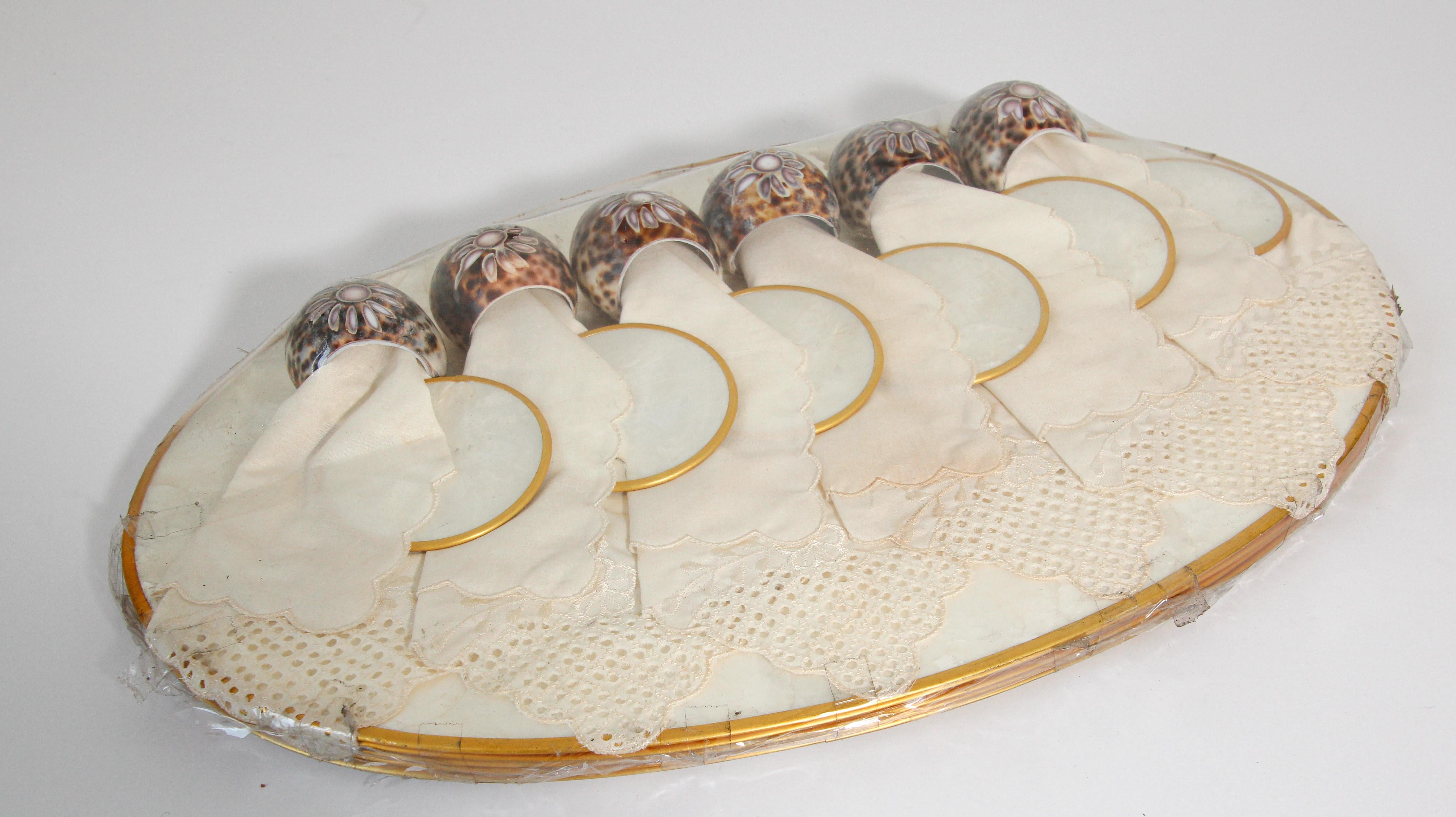 Vintage Hallie St Mary placemats, set of six capiz, pearl shell design oval placemats set with brass rim.
Luminous, beautiful mother of pearl shell color.
The reverse of these placemats is cork. 
These would make a beautiful, tropical and elegant