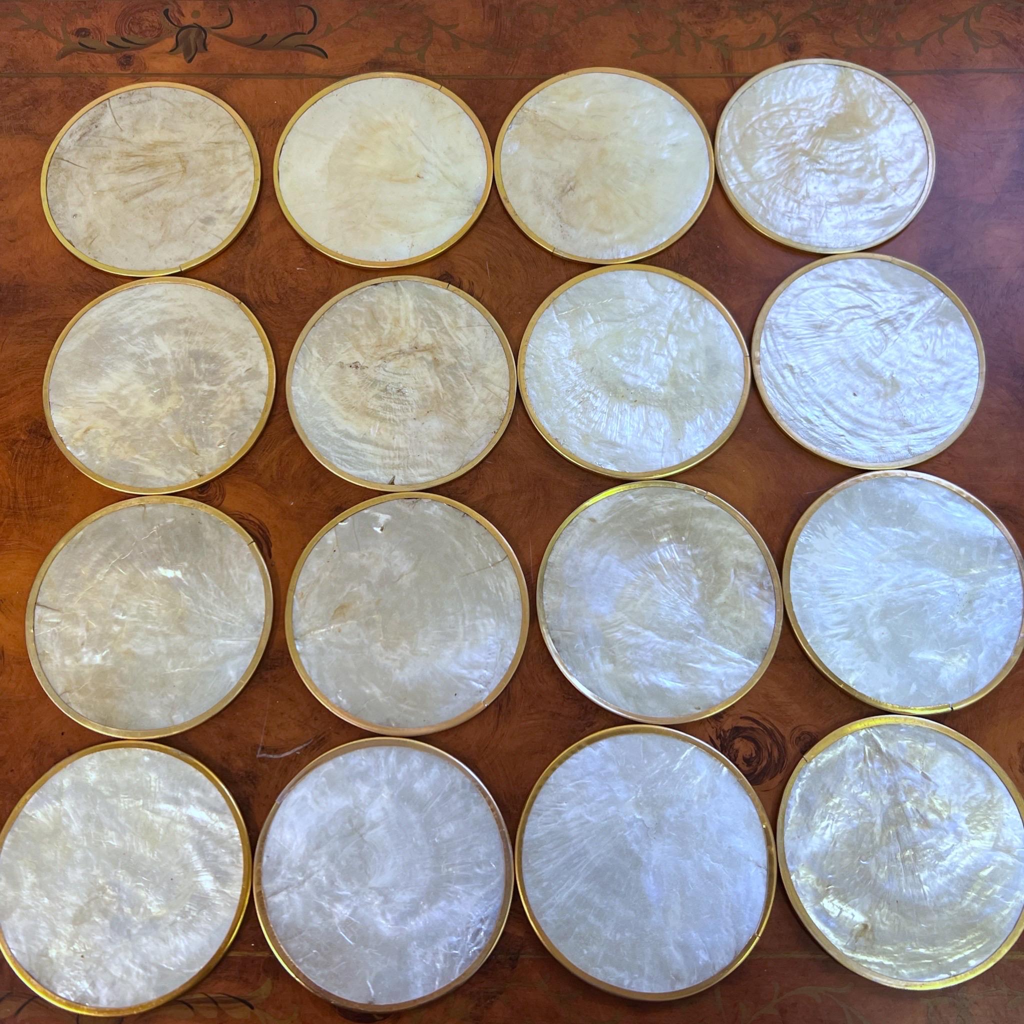 A very lovely set of cork backed capiz shell coasters with brass around the edges.  All in excellent condition.  This is for a set of 16.
