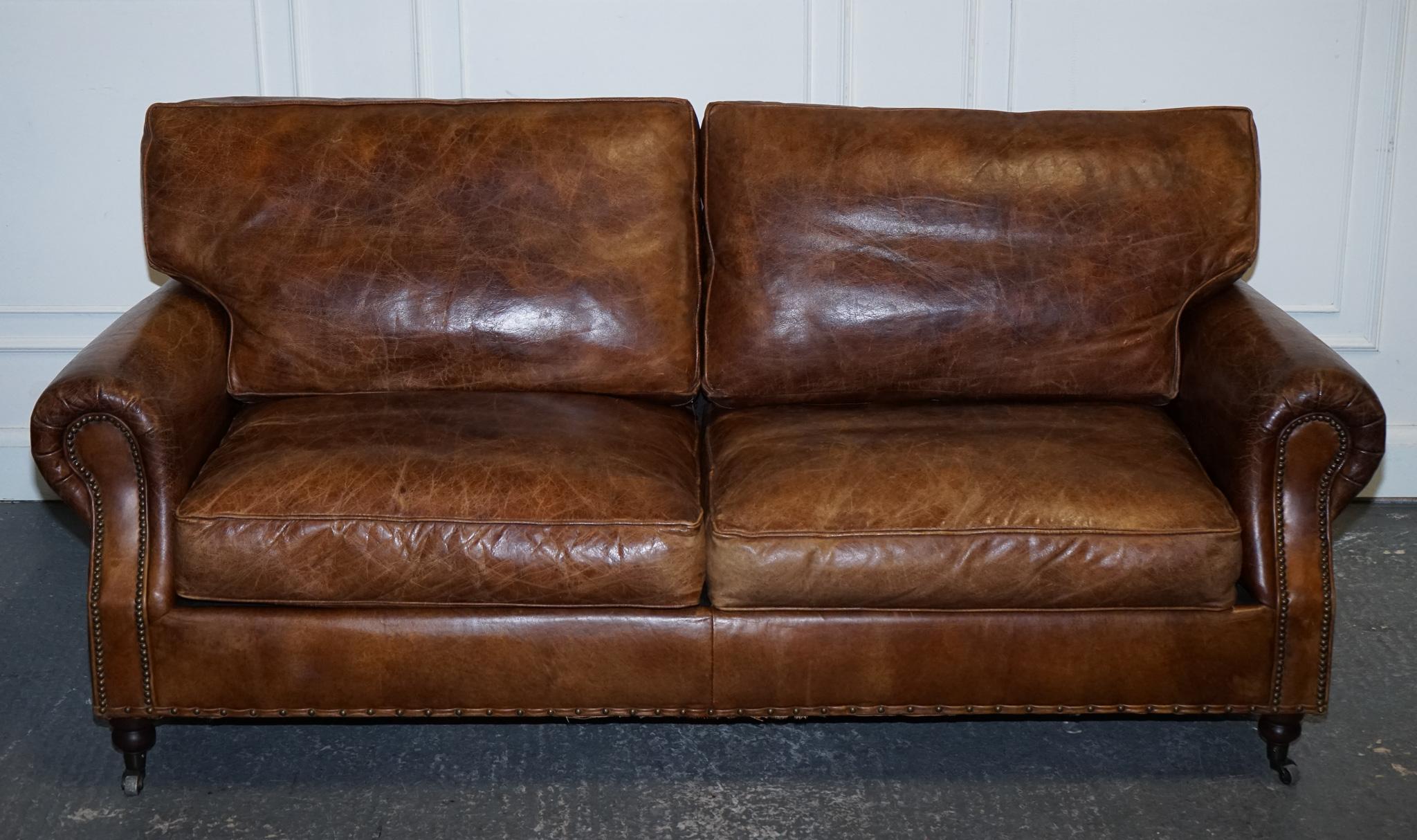 
Antiques of London

We are delighted to offer for sale This Vintage Halo Timothy Oulton Balmoral Two-to Three-seater Brown Leather Sofa.

 Is a stunning blend of classic design and contemporary comfort, embodying the elegance of timeless