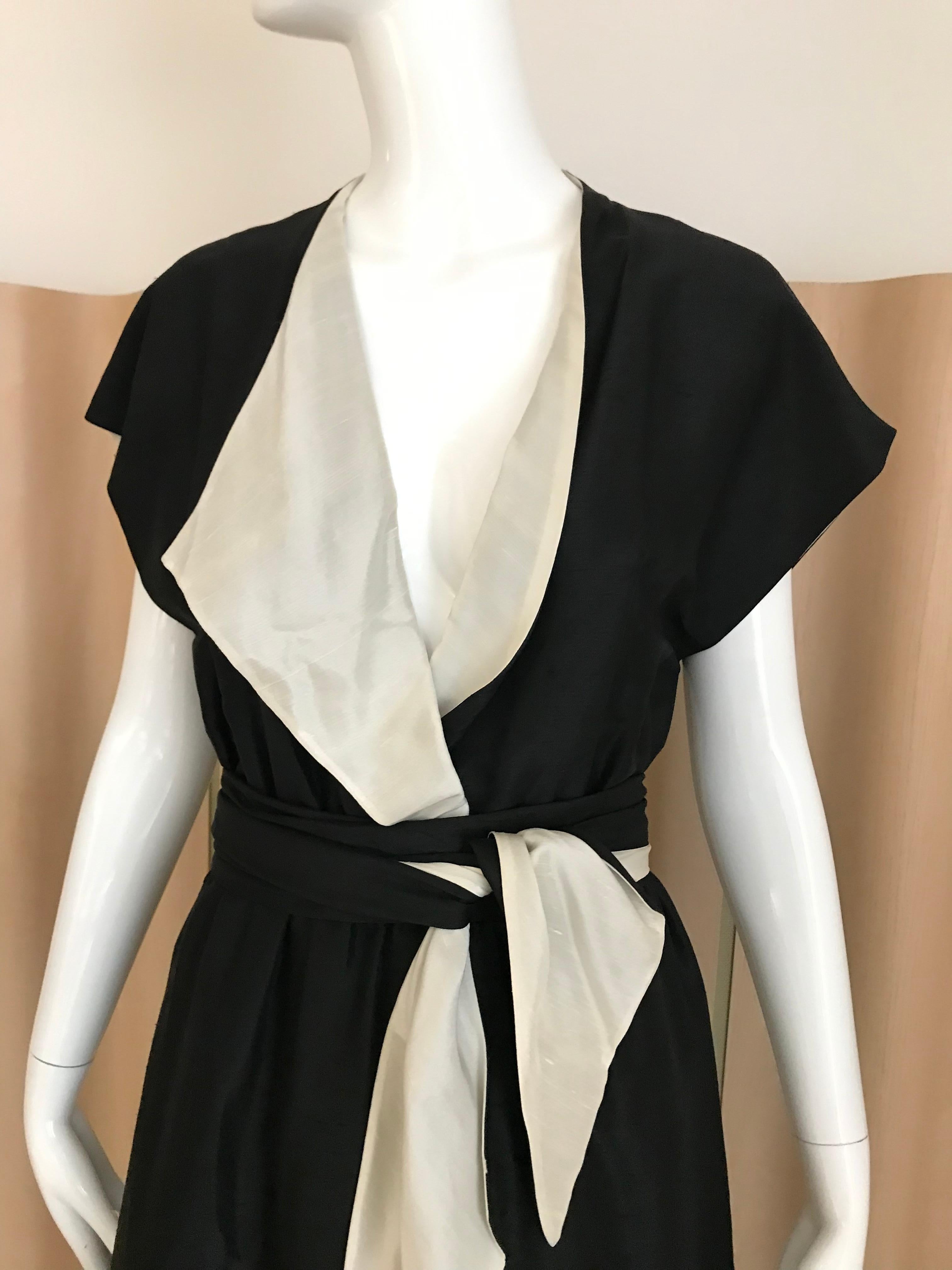 Timeless Vintage HALSTON Black and Cream silk wrap cocktail  dress with elastic waist with silk sash. Fit size 6
Dress has creme silk lining.  
Bust: 36 inches/ elastic waist 