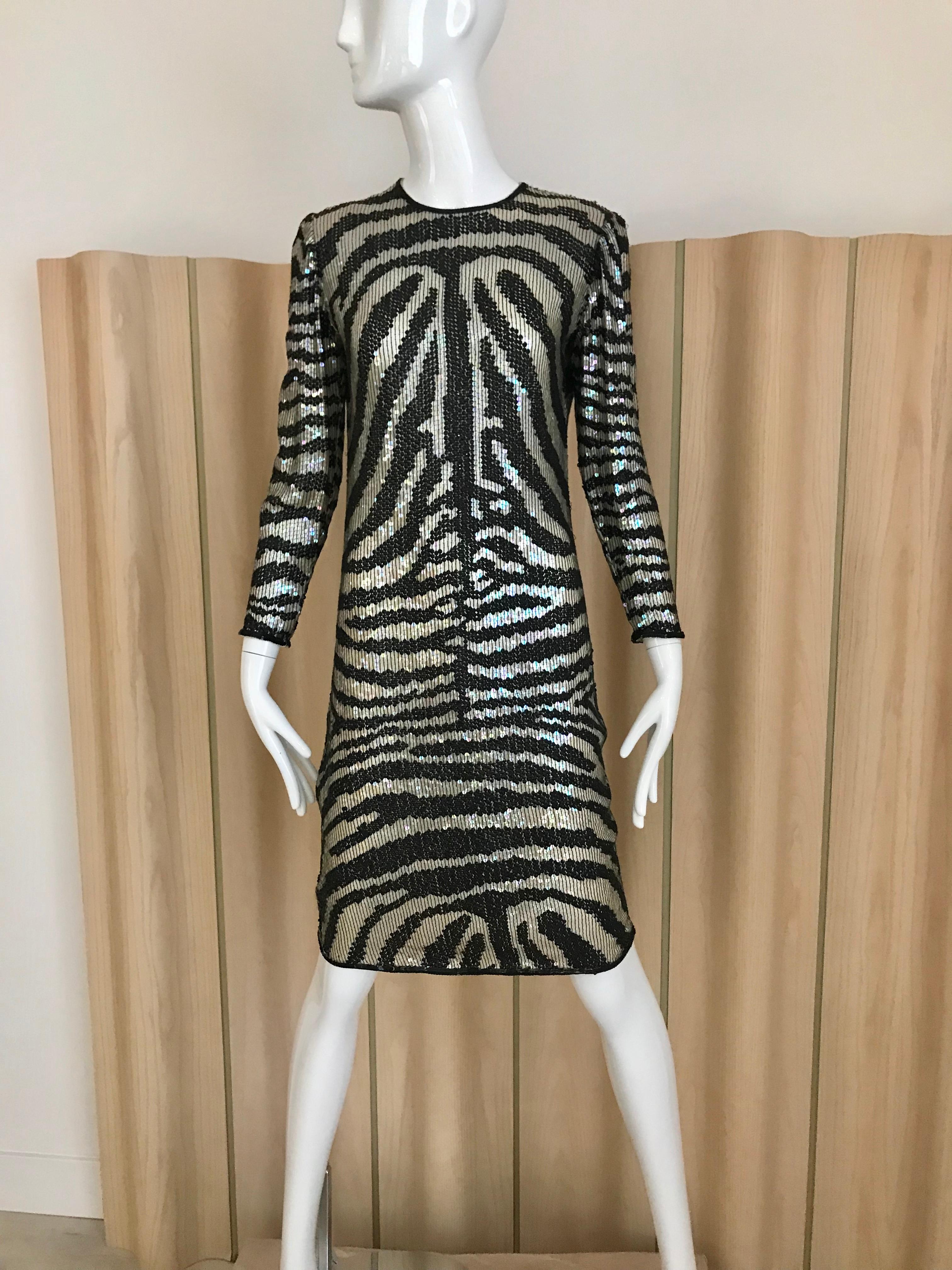 1970s vintage Halston black and silver sequins animal print cocktail sheath dress.
Dress has narrow wrist circumference. If you have large hand this will be really tight. 
*** sleeve has been taken in about half inches ( see image attached)
This