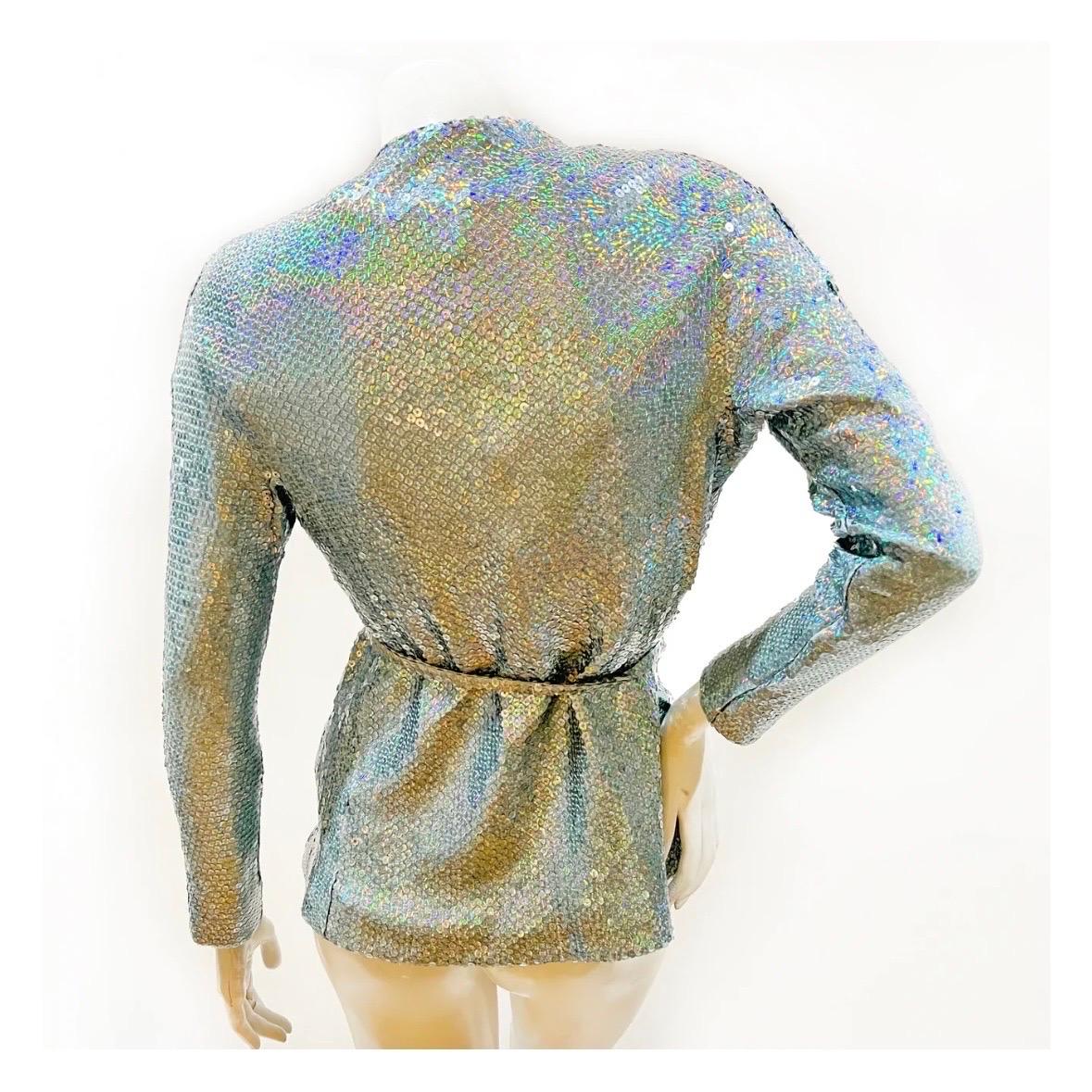 Holographic sequin top set by Halston
1974
Top, jacket and belt set
Aqua holographic sequins throughout 
Top has a back zip closure 
Jacket has a single front hook closure 
Sequin shell with silk chiffon lining
Excellent vintage condition; Preloved