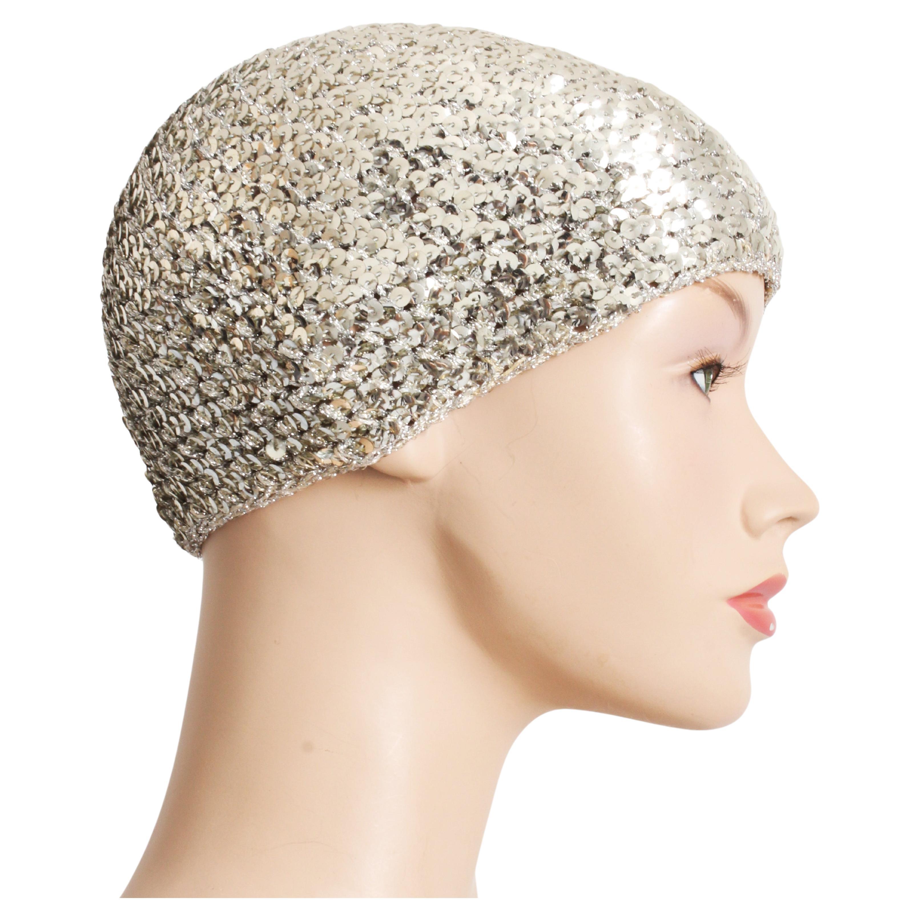 Get your disco groove on with this preowned, vintage Halston sequins skull cap hat or beanie, likely made in the 70s.  Made from a stretchy knit, it's covered in silver sequins which sparkle and shimmer in light!

Tagged Halston.  No size tag, best
