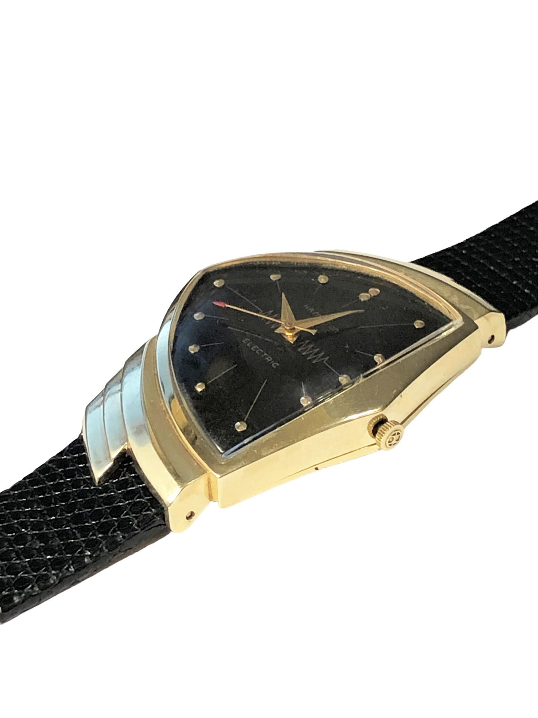 Circa 1960 Hamilton Electric Ventura Wrist Watch, 14k Yellow Gold 2 piece case, Hamilton 505 Electronic movement, Black dial with raised gold markers and a sweep seconds hand. New Black Lizard strap, comes with a Hamilton Electric information and