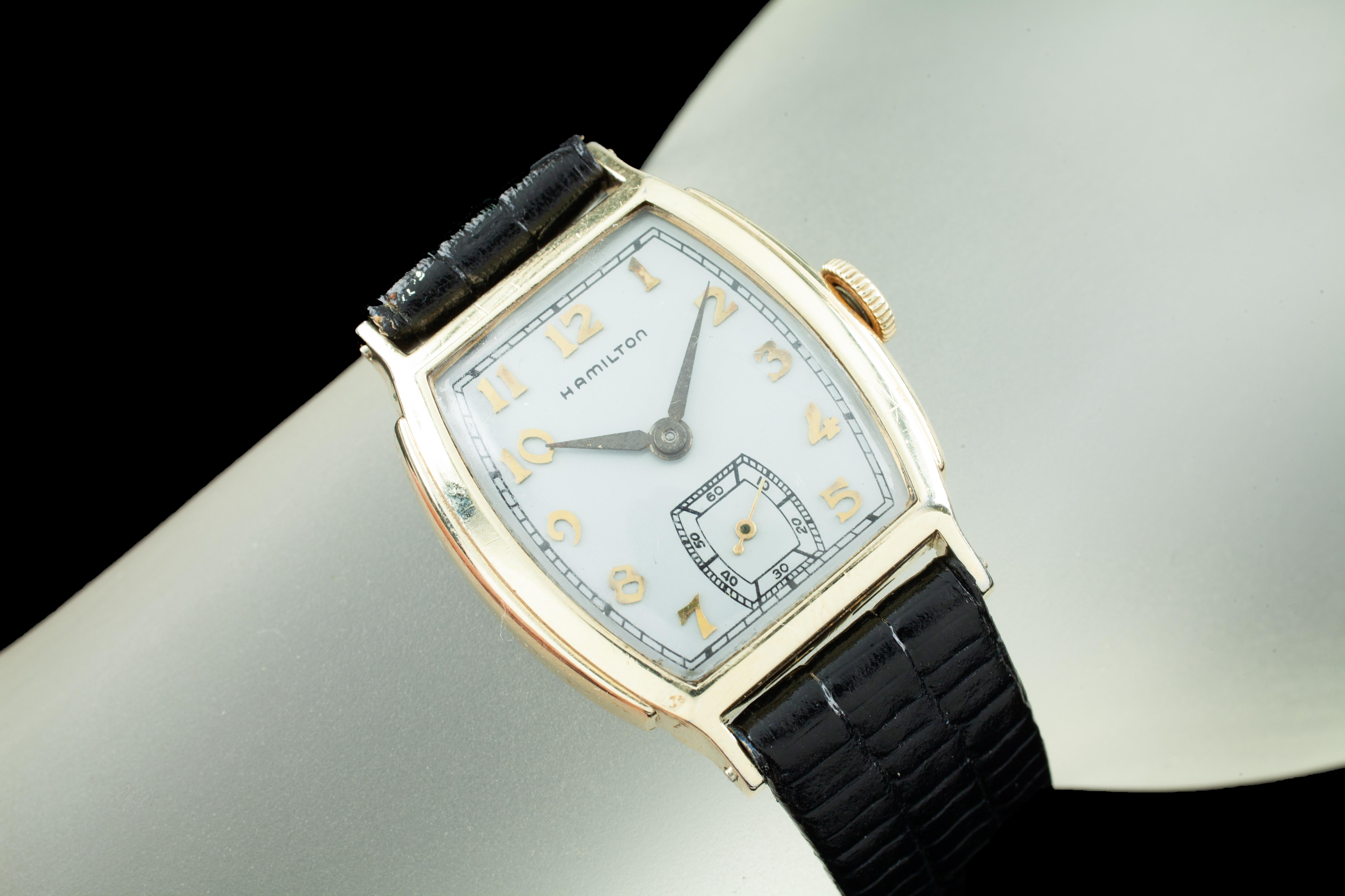 Case # H857441.
Manual movement # 987A0421050.
Weight: 26.5 grams.
Does not include original box or papers.
This watch is guaranteed authentic.
One year warranty included with purchase.

Gold-plated tonneau case.
Dimensions: 27 x 26 mm.
Lug-to-Lug: