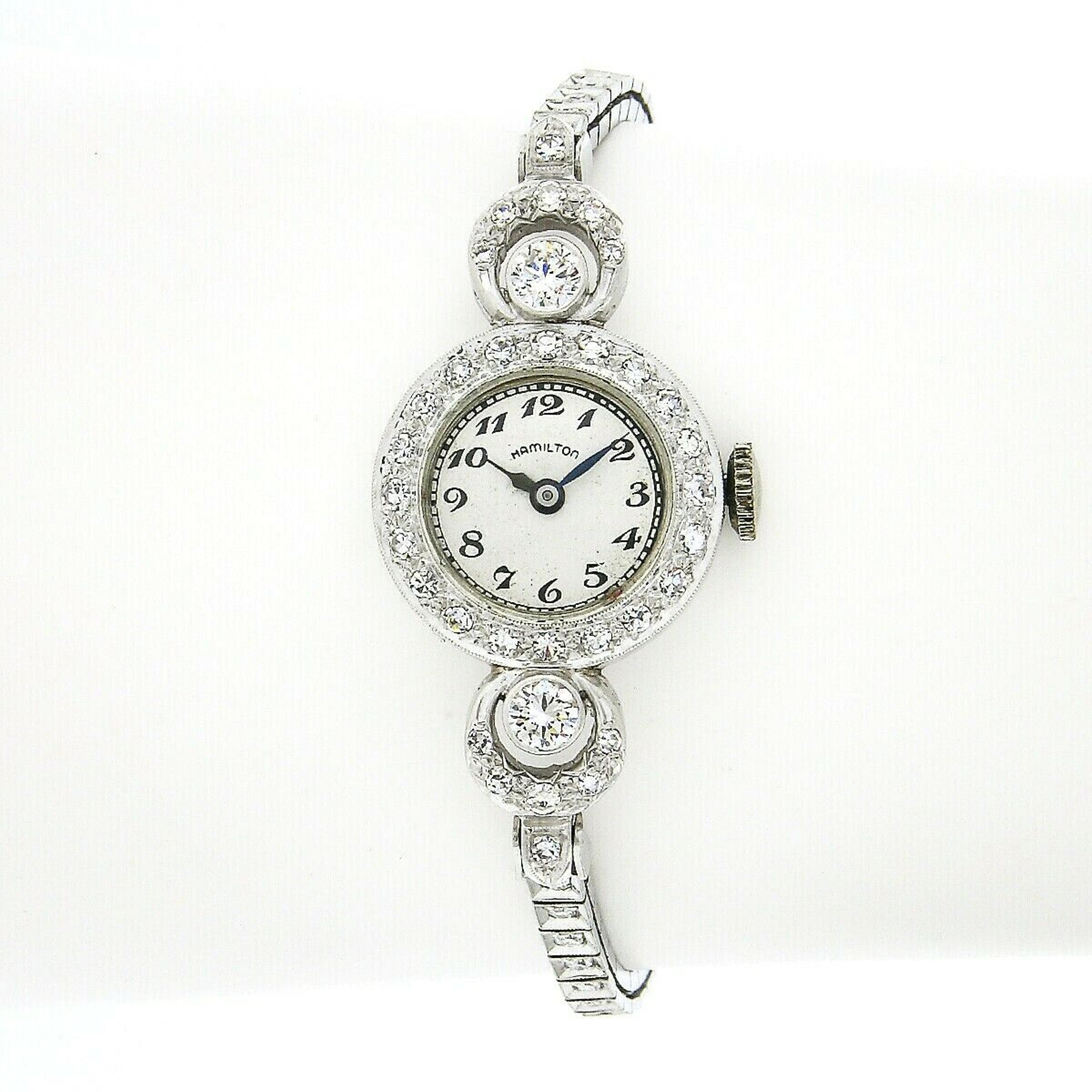 Here we have a fancy vintage Hamilton ladies' watch crafted in solid platinum and is covered throughout with approximately 2 carats of fine quality diamonds. It is set with two round brilliant cut diamonds at the top, each showing a nice large size,