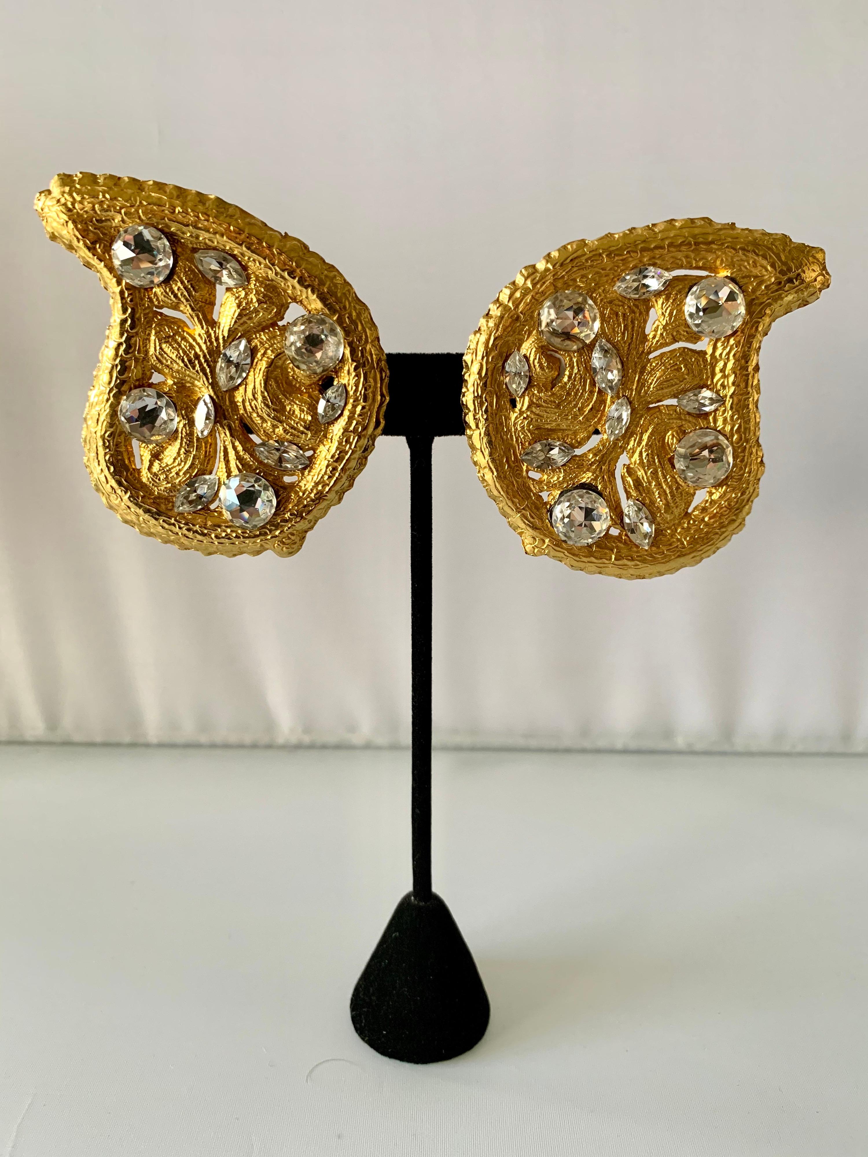 Boucles d'oreilles clips vintage surdimensionnées à motif cachemire,  Composé de métal doré, hautement détaillé à la manière byzantine et rehaussé de gros strass diamantés. Fabriqué en France, signé Yves Saint Laurent, circa 1980.