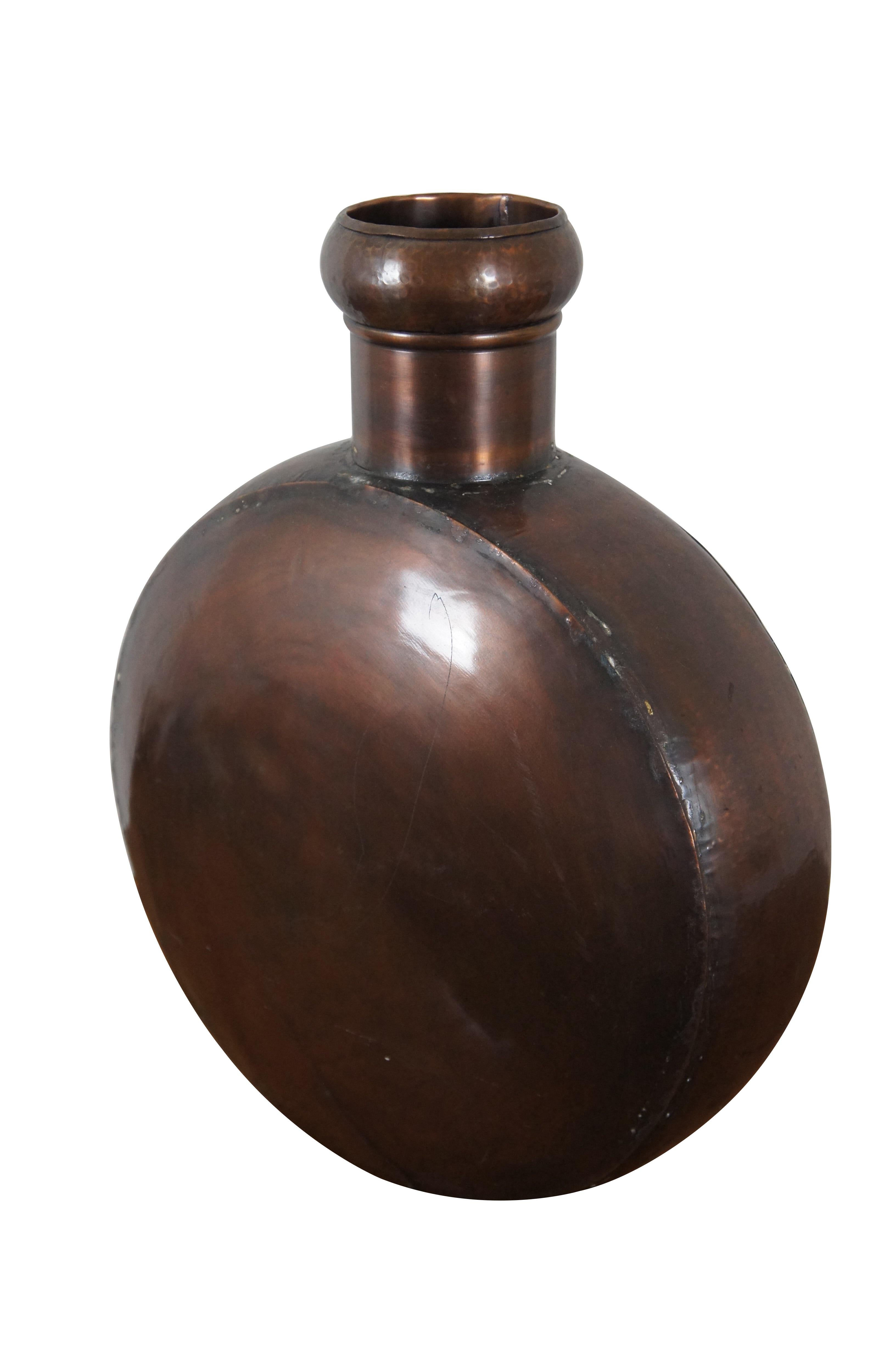 Vintage large scale copper flask / canteen with a round body and hammered rim. No stopper. No makers mark.

Dimensions:
16” x 7” x 21” (Width x Depth x Height)