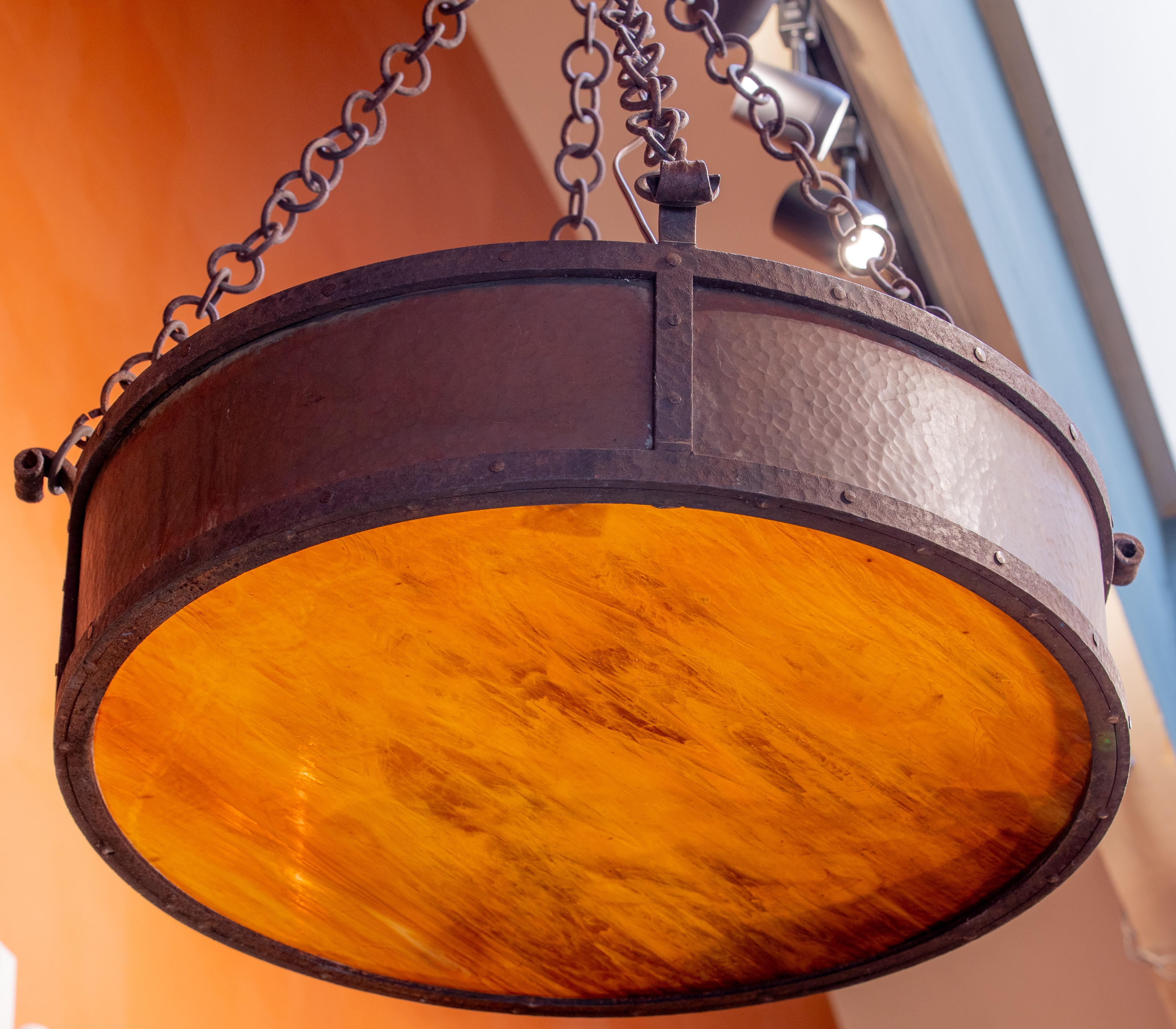 This One-of-a-kind Arts and Crafts Style Light was made of hand-hammered copper and forged iron.  The art/slag glass has been replaced.  It has been wired in the US.  The light would be so pretty in an entry way, a wine room or anywhere where an