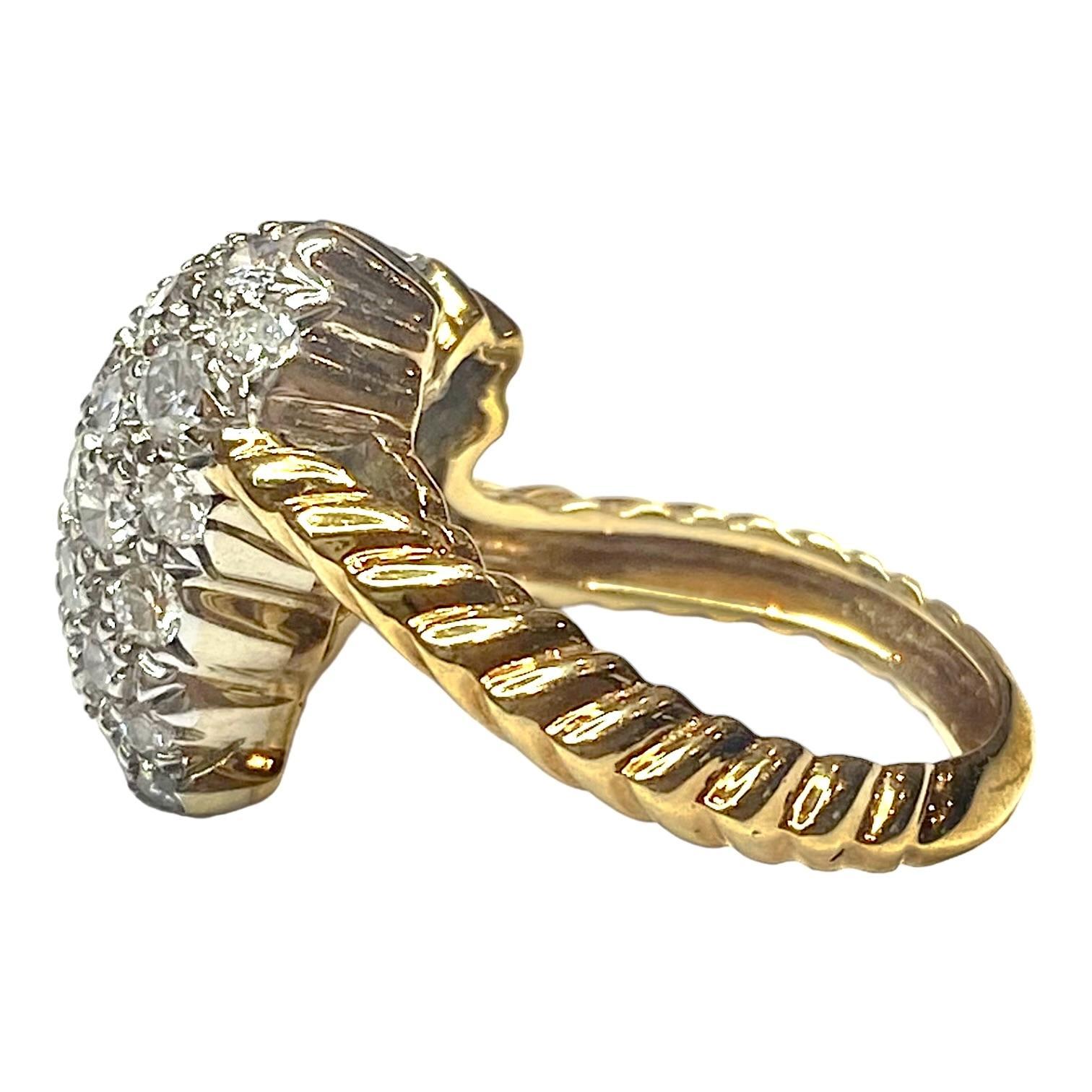 Vintage Hammerman Brothers ring crafted in 18K yellow gold, featuring a diamond encrusted heart with a tail slanted to the right, supported by a twisted rope style band. Bright polish finish with rhodium accents.
41 round brilliant cut diamonds: