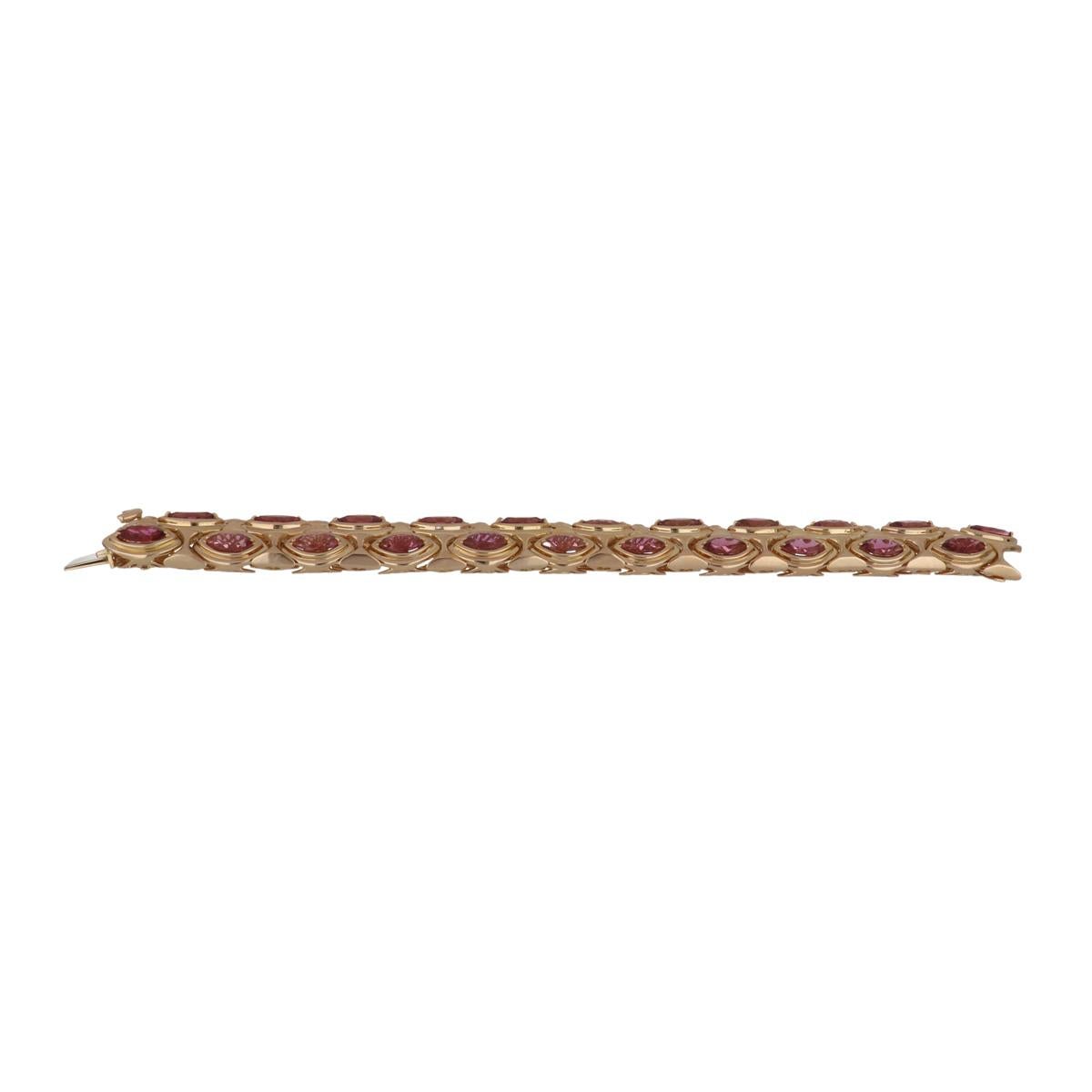 Hammerman Bros. geometric link bracelet composed of 18K yellow gold featuring pink tourmalines.  There are 33 marquise-shaped tourmaline stones that total 26.50 carats.  The bracelet has a nice fluid movement to it. It measures 7 1/2 inches in