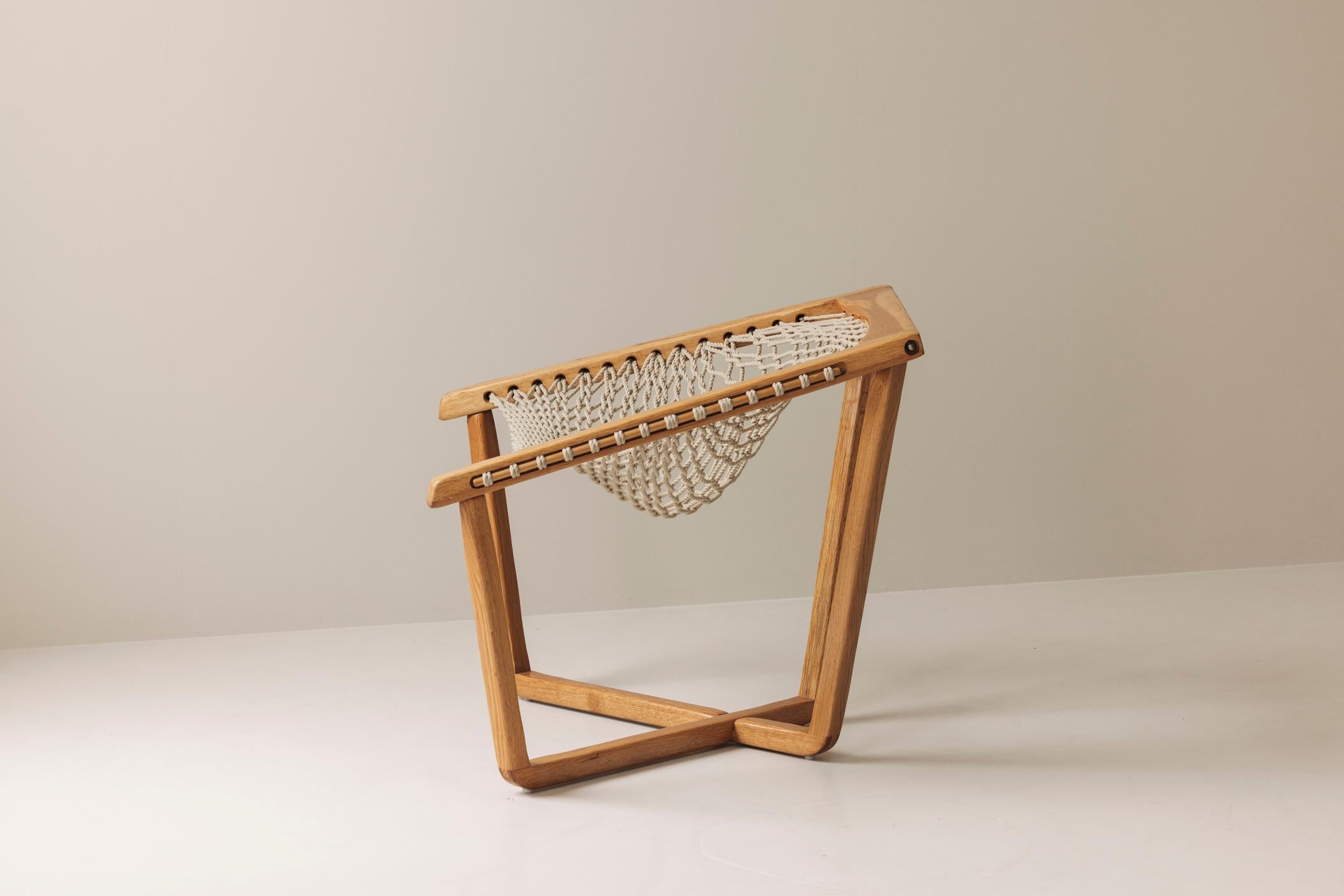 Step into the elegance of mid-century design with this rare 1970s rope chair, a striking example of Swedish minimalism at its finest. Crafted from solid blond oak and featuring a handwoven rope seat in an open lattice pattern, this chair balances