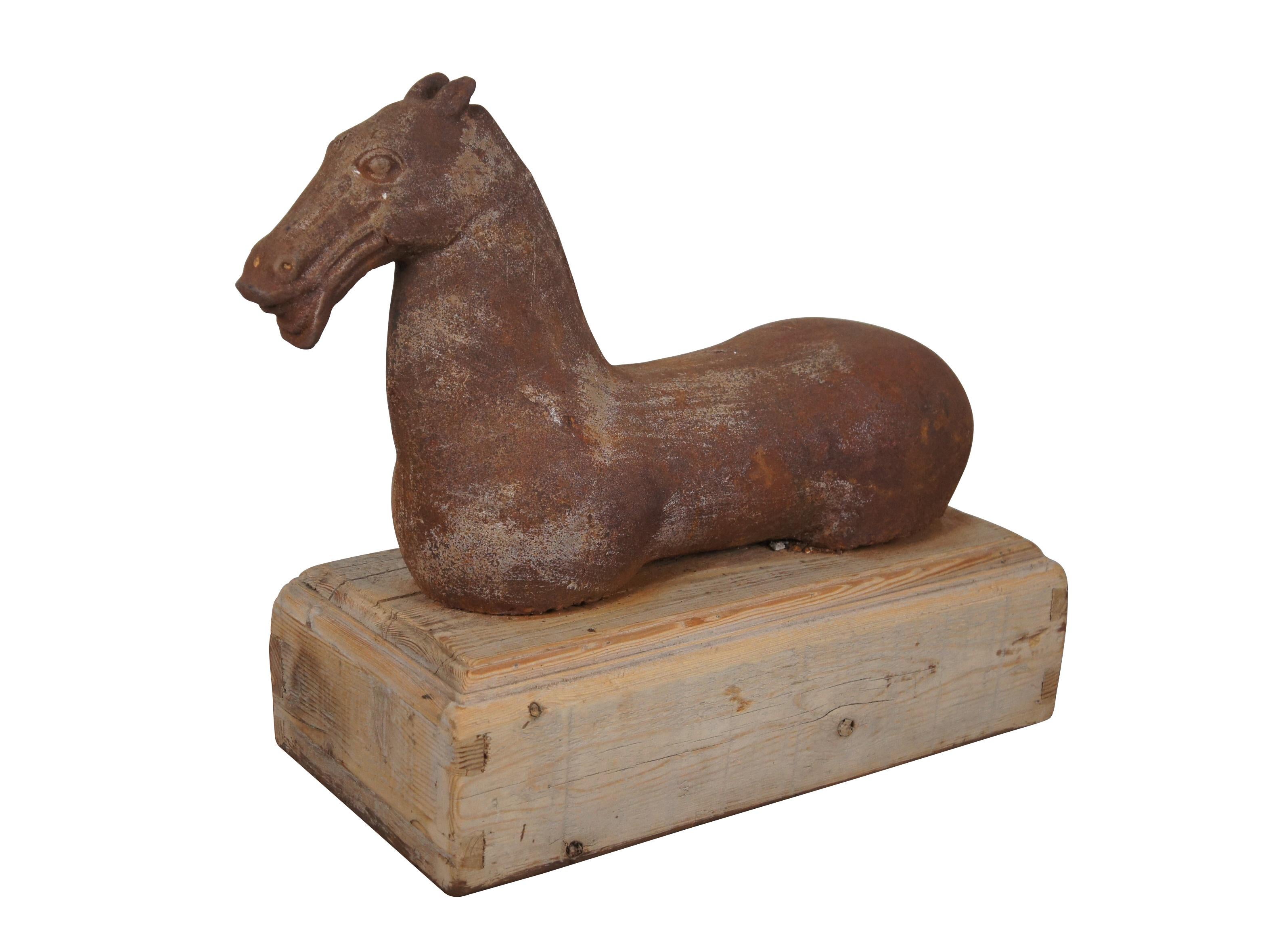 20th century cast iron sculpture or hitching post of a Han (or Tang) Dynasty style horse with muscular cheeks, open mouth and no legs. Mounted on a hollow, dovetailed, un-finished wood base.

Dimensions:
20.75