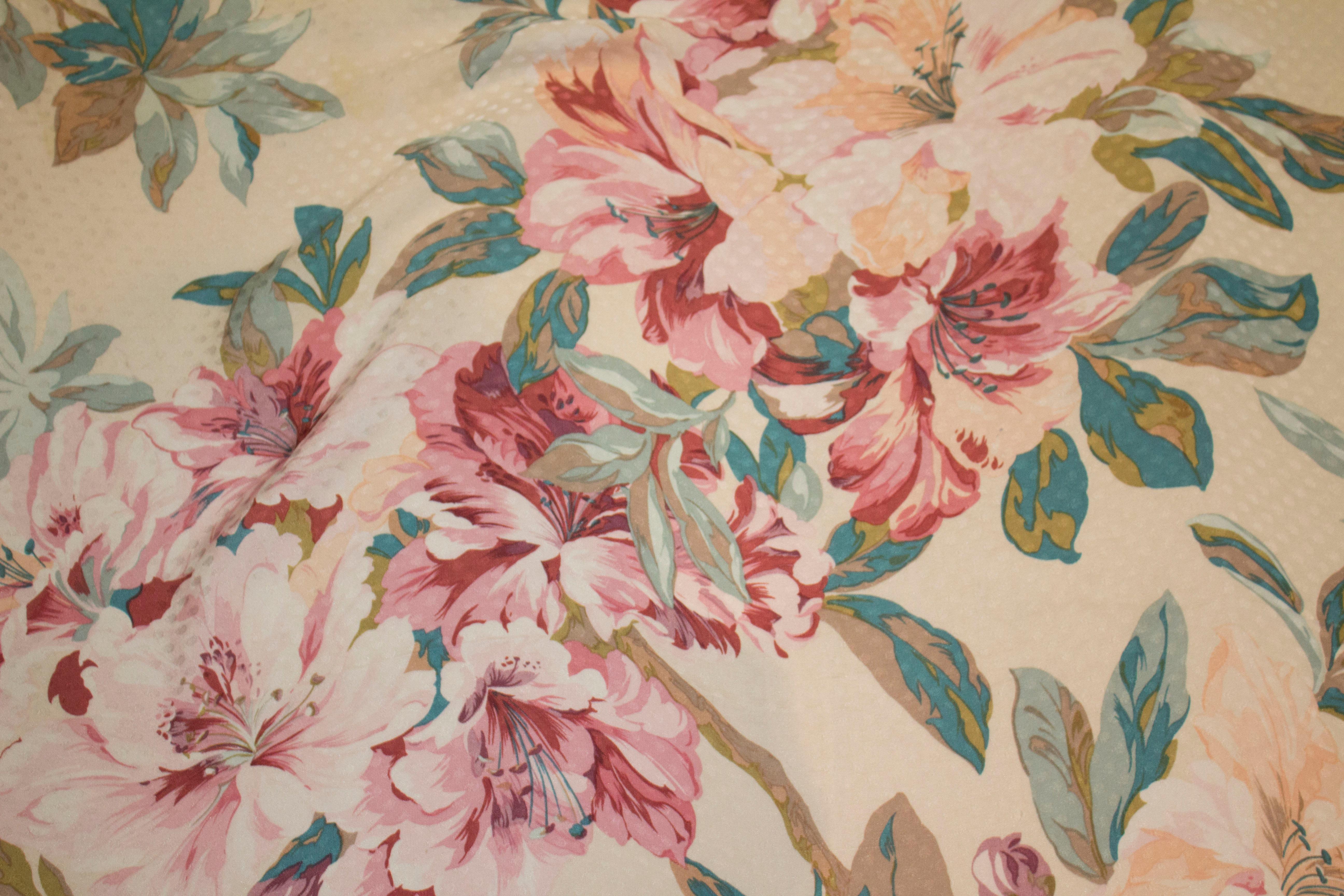 A pretty vintage silk scarf by Hanae Mori.  The  scarf has a spot effect and a floral print in shades of pink, turquoise  and brown. 