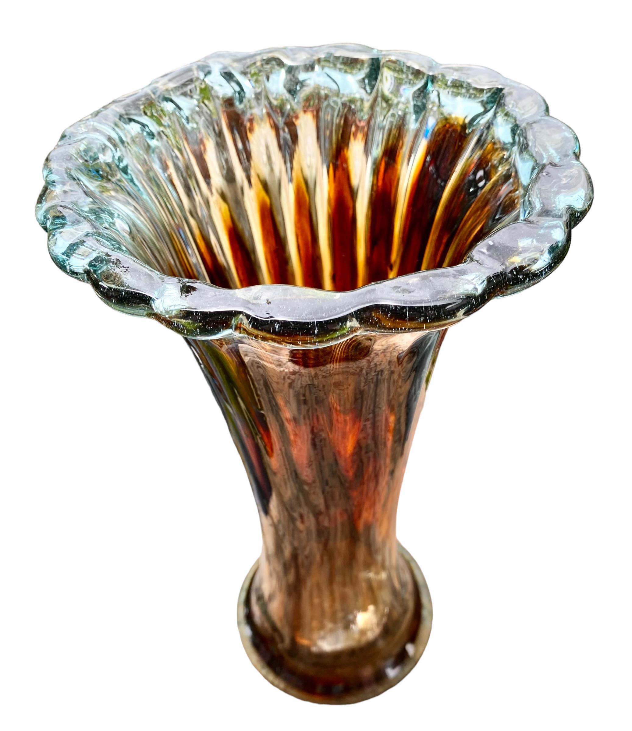 A vintage Bohemian hand blown art glass flower vase having a lovely ribbed design and ruffled top in shades of brown and tints of blue. Ready for your colorful display of fresh flowers.   