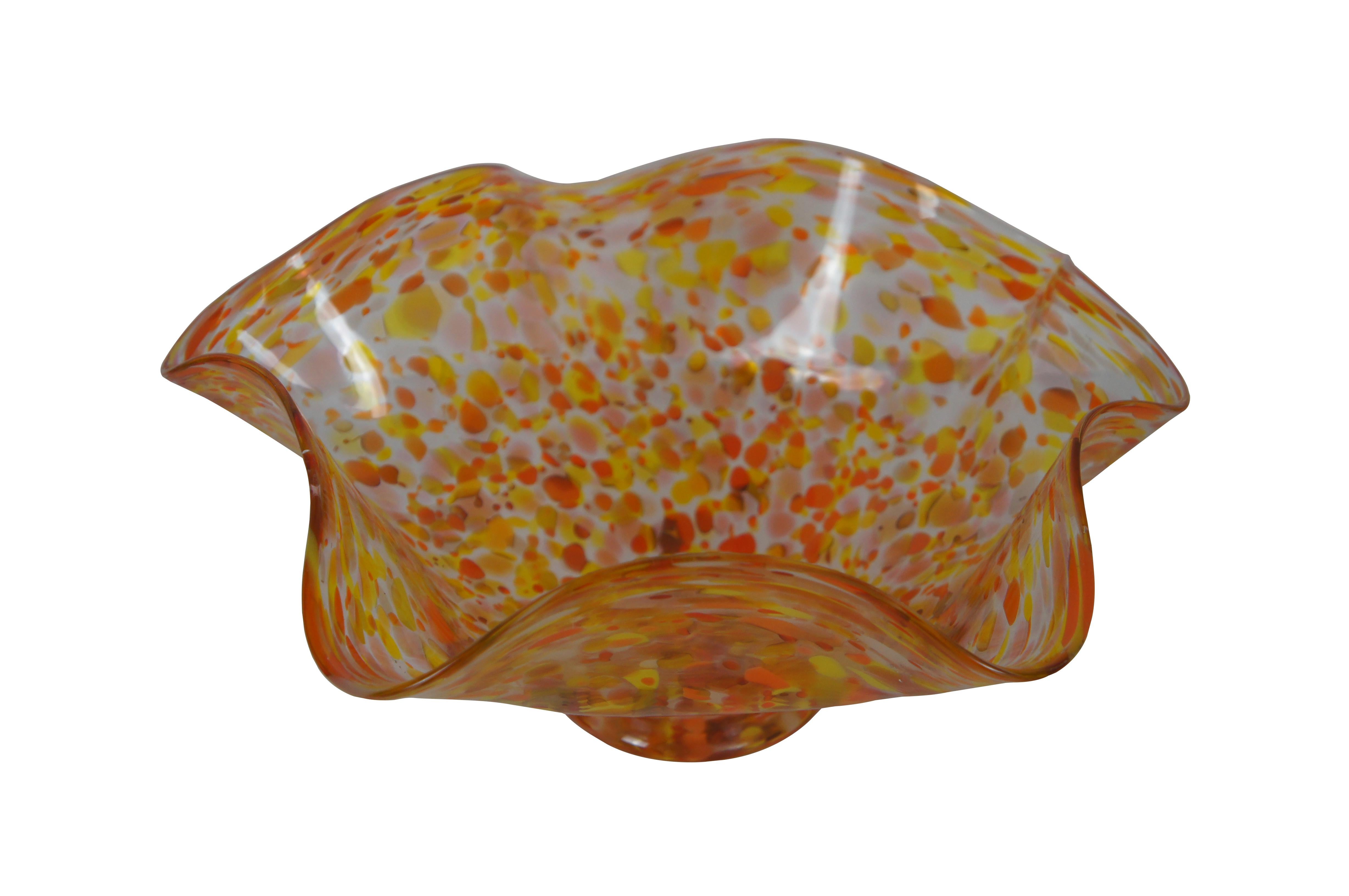 Intriguing hand blown footed free form ruffled centerpiece bowl.  Features a swirl of yellows and oranges.

Dimensions:
13.25