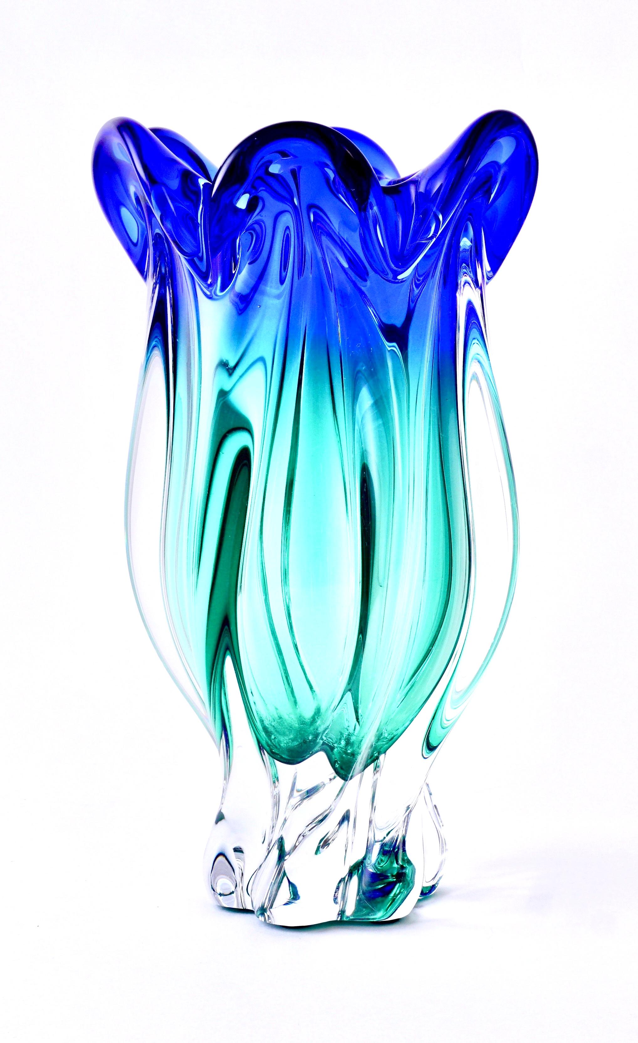Beautiful vintage hand blown Murano Sommerso art glass flower vase, circa 1950
Italy, Mid-Century Modern. Twisted Sommerso cobalt blue & aqua green, with a scalloped top reminiscent of a flower. One of the more beautiful and useful Murano vases