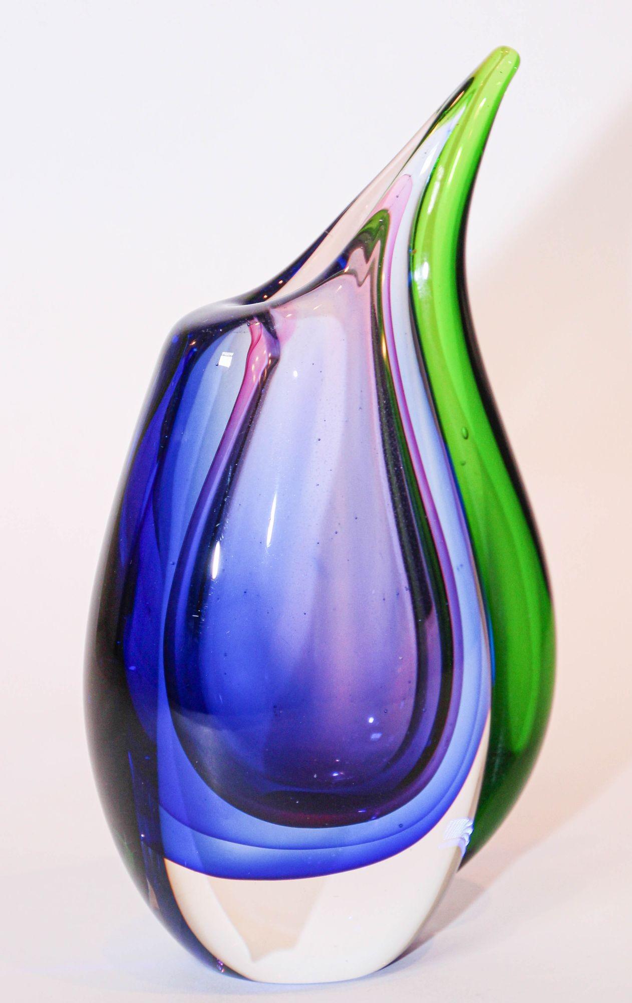 Vintage stunning hand blown art glass masterpiece with an extravagant shape.
Beautiful Design of a tear drop shape in bright vibrant intense striking rich colors in dark blue, purple and green colors hand blown and crafted entirely by hand using