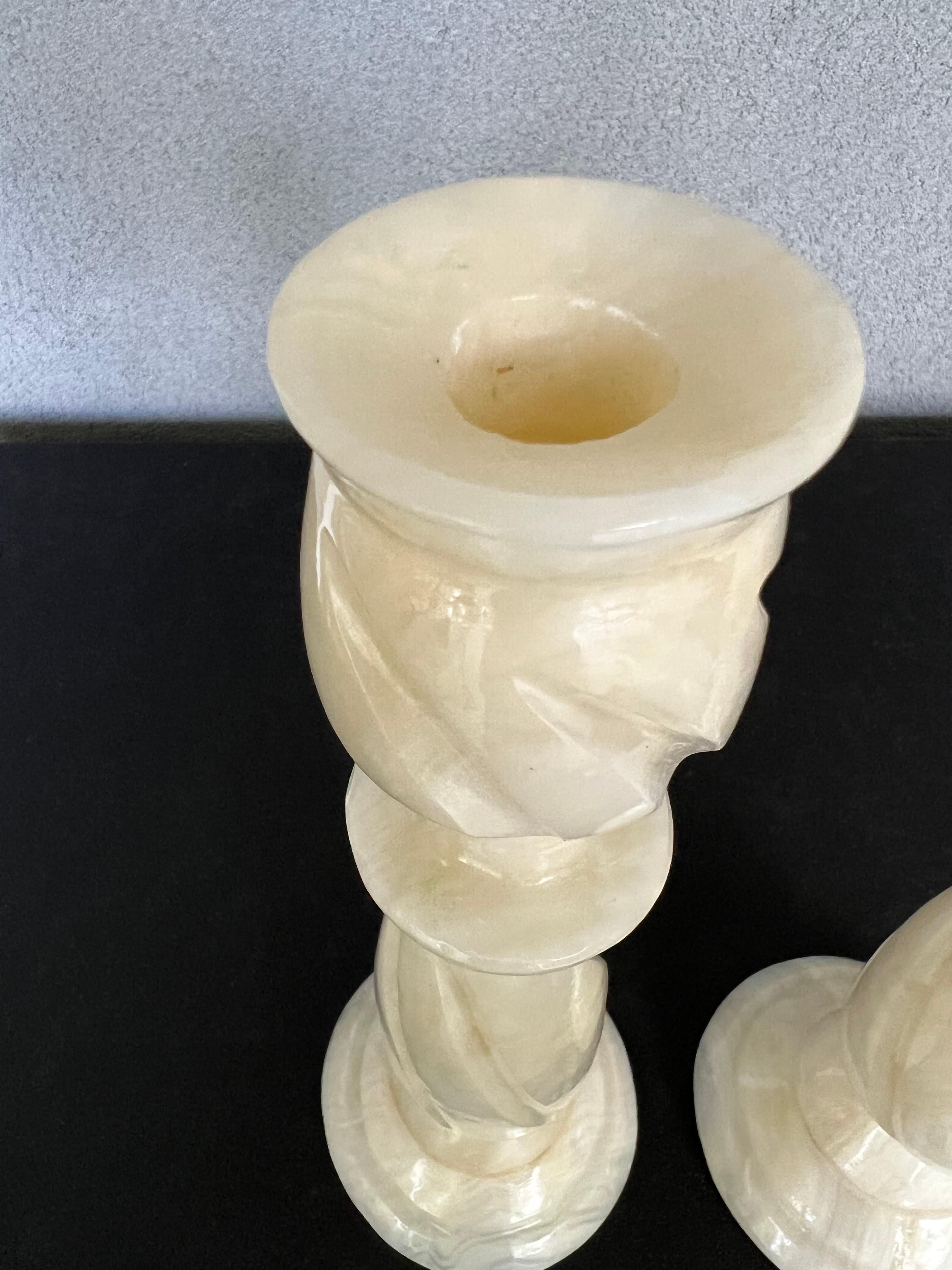 Gorgeous pair of vintage hand carved Alabaster marble candlesticks. 
Each weighs 2.7 pounds 
Beautiful classy design that would go with any decor.