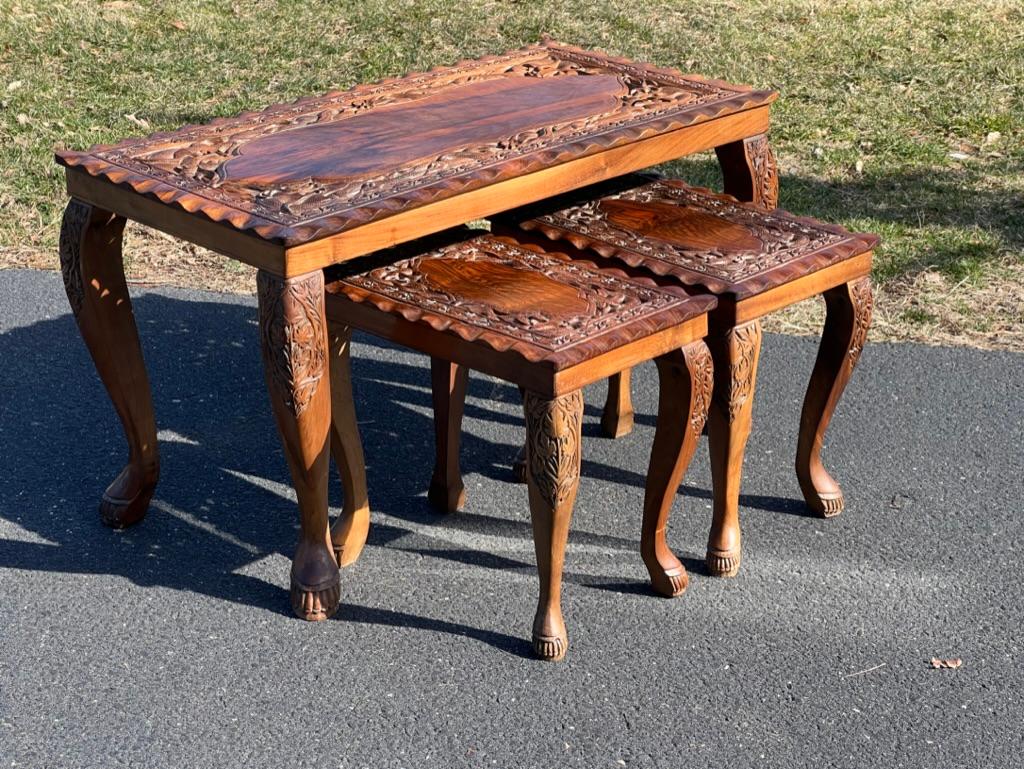 Introducing Vintage Hand Carved Asian Fruitwood Nesting Tables, exquisite pieces that blend cultural artistry with practicality. Crafted from fine fruitwood and adorned with intricate hand-carved designs, each table showcases traditional Asian