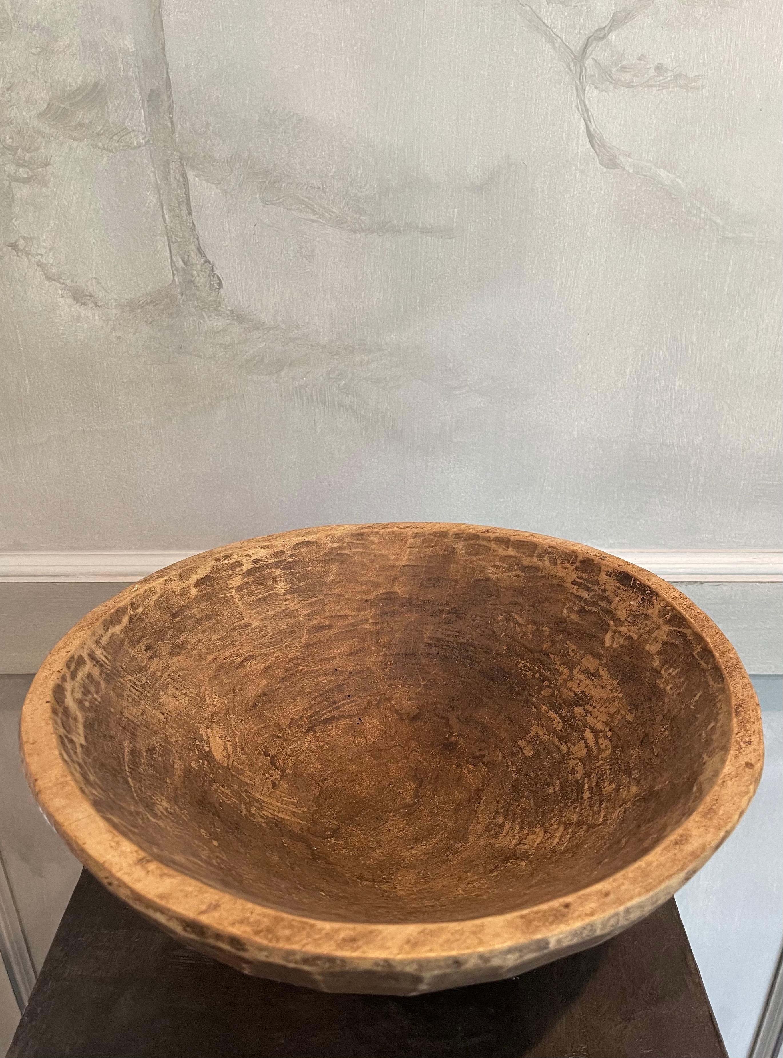 Vintage 1960's hand carved wooden bowl. Carefully carved from a single piece of wood with unique indents and a beautiful patina.