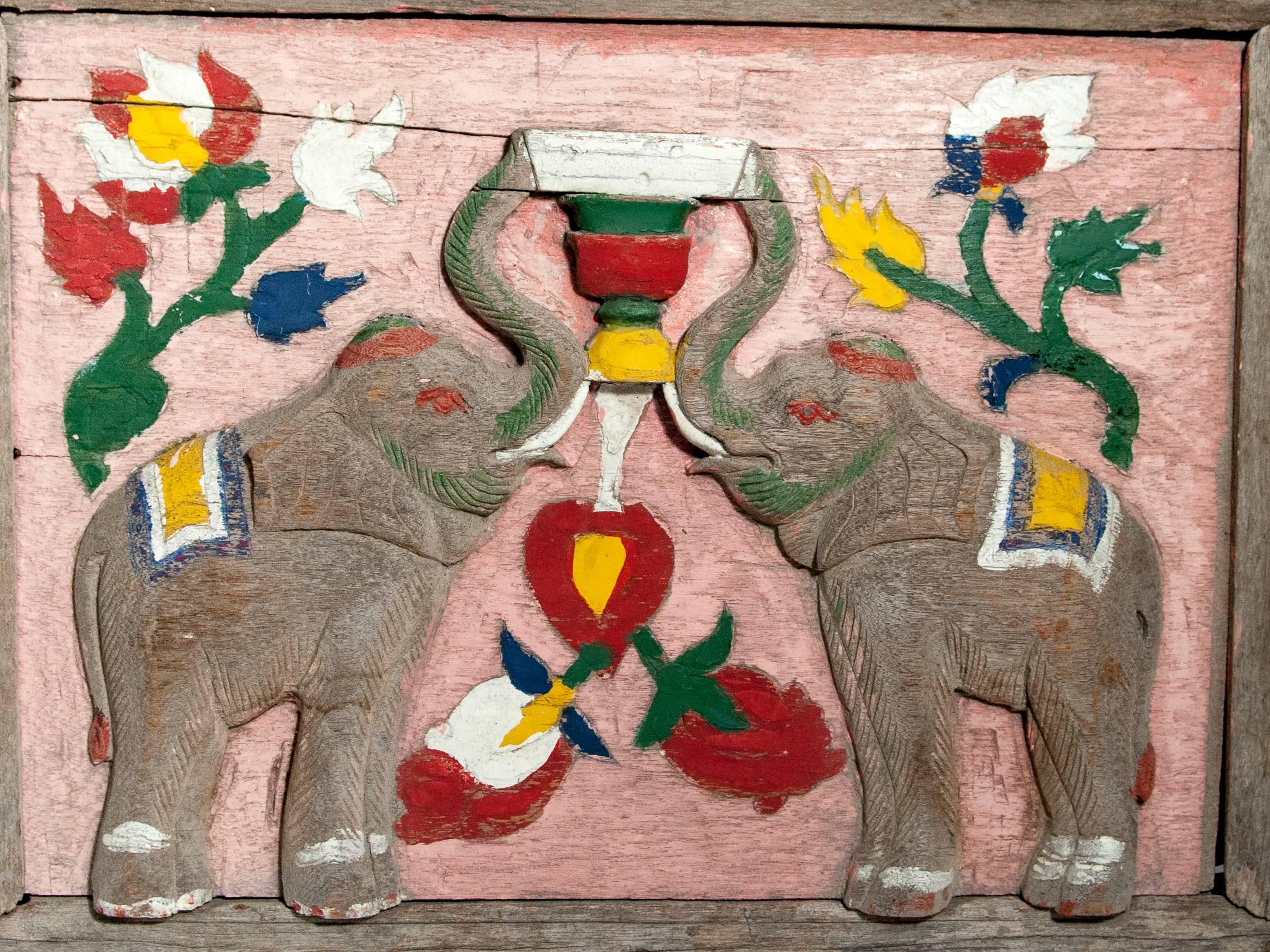 Vintage hand-carved cart panel. Elephant motif. Teak, mid-20th century. North Thailand.
This colorful three dimensional hand carved and painted teak panel was the back decorative piece from a Thai two wheeled cart. Hardware and wire for hanging has