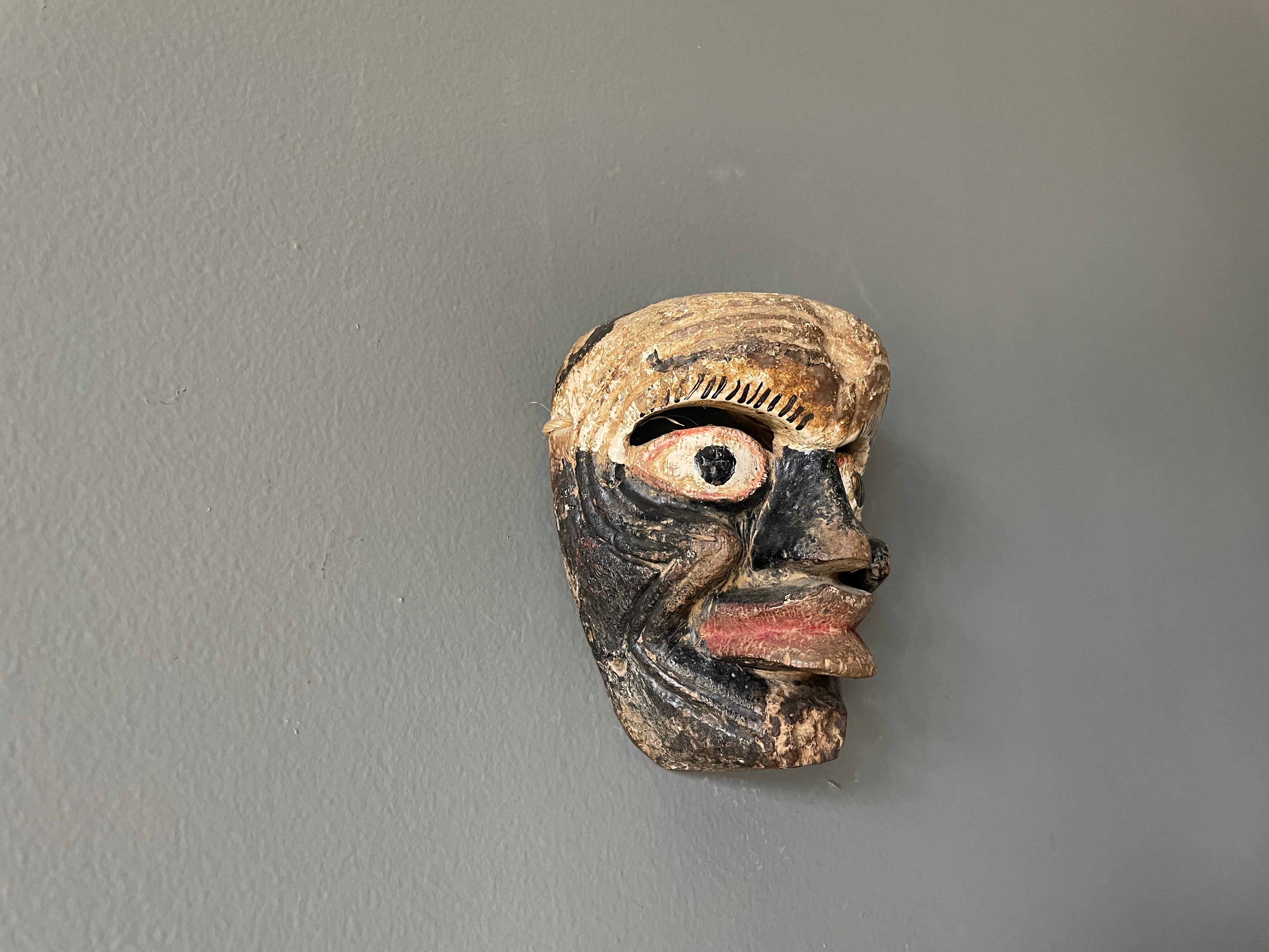 Vintage hand carved tribal ceremonial mask. Small in stature, most likely fashioned for a child. A one of a kind conversation piece in any room it's placed in.