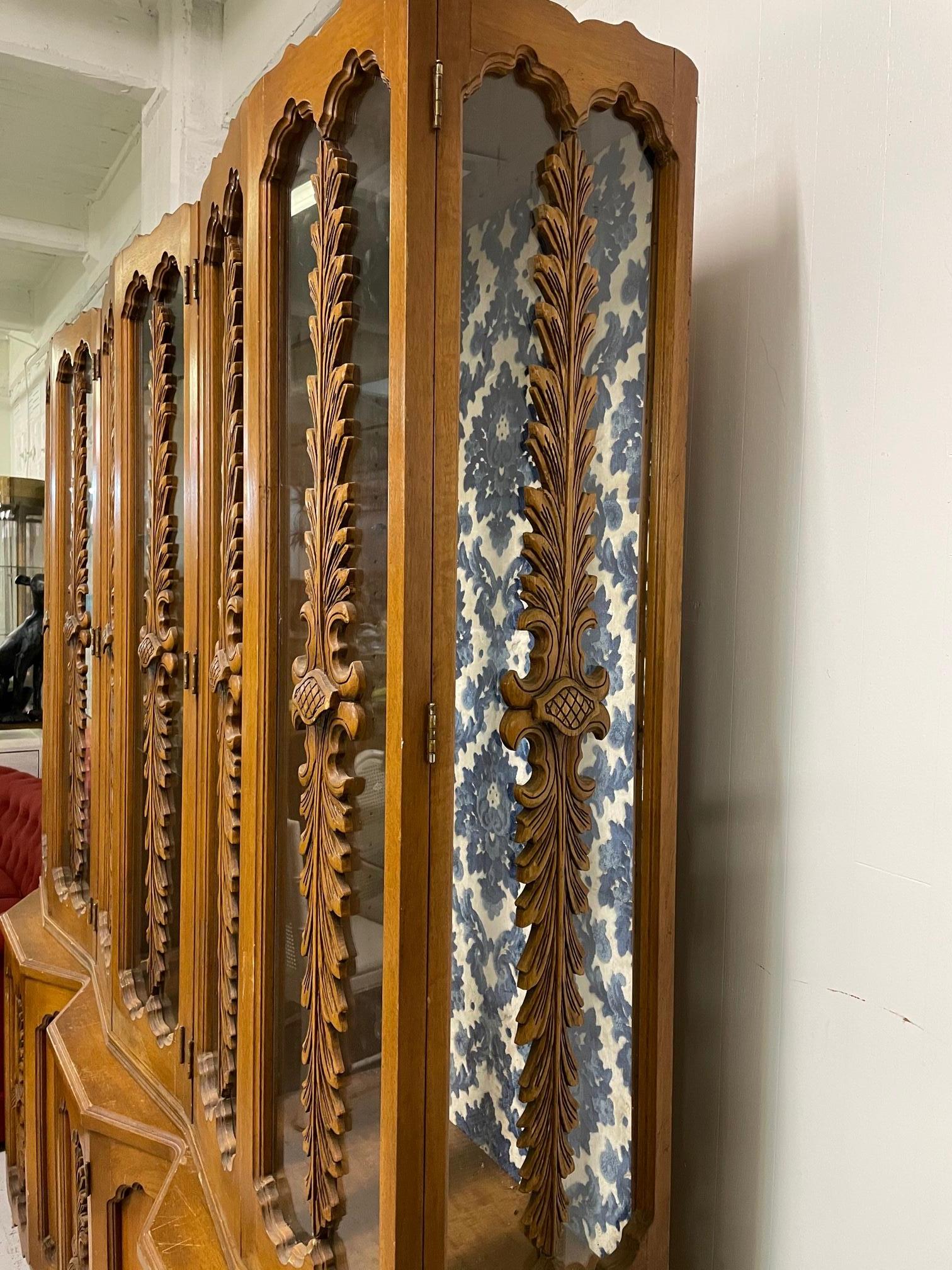 Vintage display cabinet features hand carved detailing in an acanthus leaf motif. Good vintage condition with minor imperfections consistent with age.