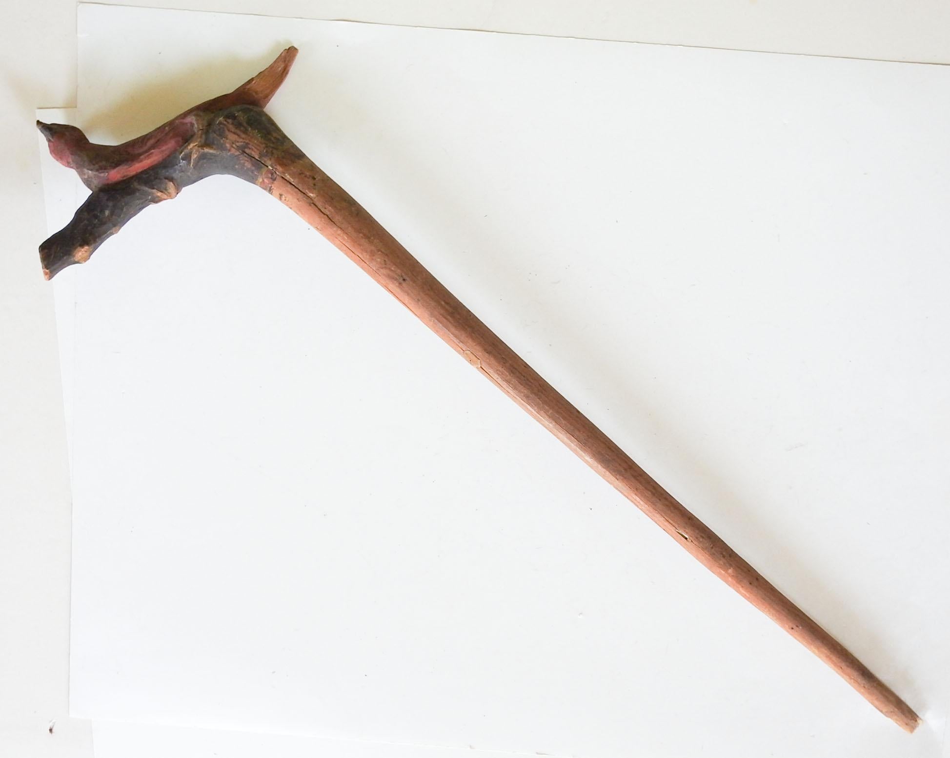 Vintage circa 1940s hand carved Folk Art cane by Fritz Rummler (1888-1983) Fredericksburg Texas. Branch of a tree carved into a bird with his feet gripping around the handle. The bird is painted red with a the rest of the handle painted black and a
