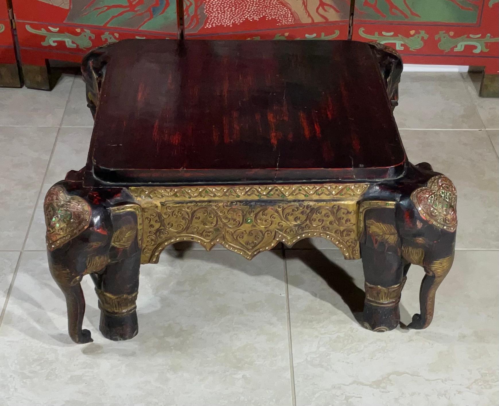 Exceptional hand carved wood stool made of four sides of elephants decorated with hand painted vine decorations with hand embedded glass beads.
Could use as low coffee table ,or very low sitting stool.
Great object of art for display.