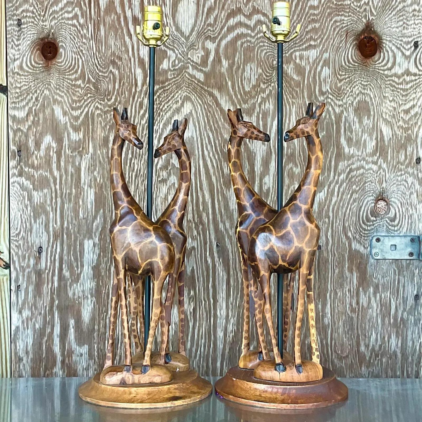 A chic pair of hand carved table lamps. Beautiful design of a pair of slender giraffes. A charming addition to any decor. Acquired from a Mimi estate.