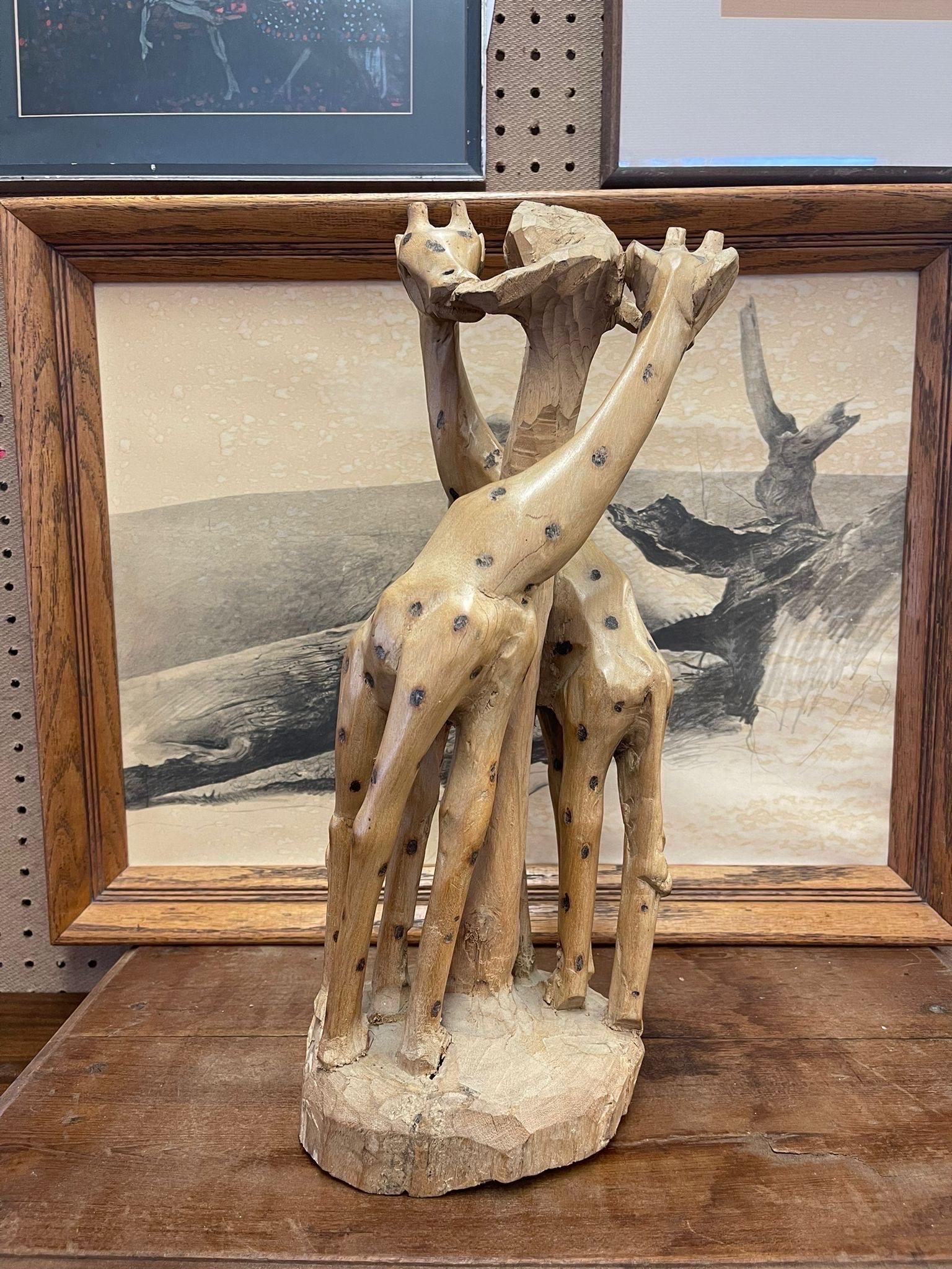 This Vintage Piece Features Two Carved Giraffes Circling a Tree. Rustic Design. The Spots Appear to Have Been Intentionally Burnt into the Giraffes. Vintage Condition Consistent with Age as Pictured.

Dimensions. 6 W ; 6 D ; 20 H
