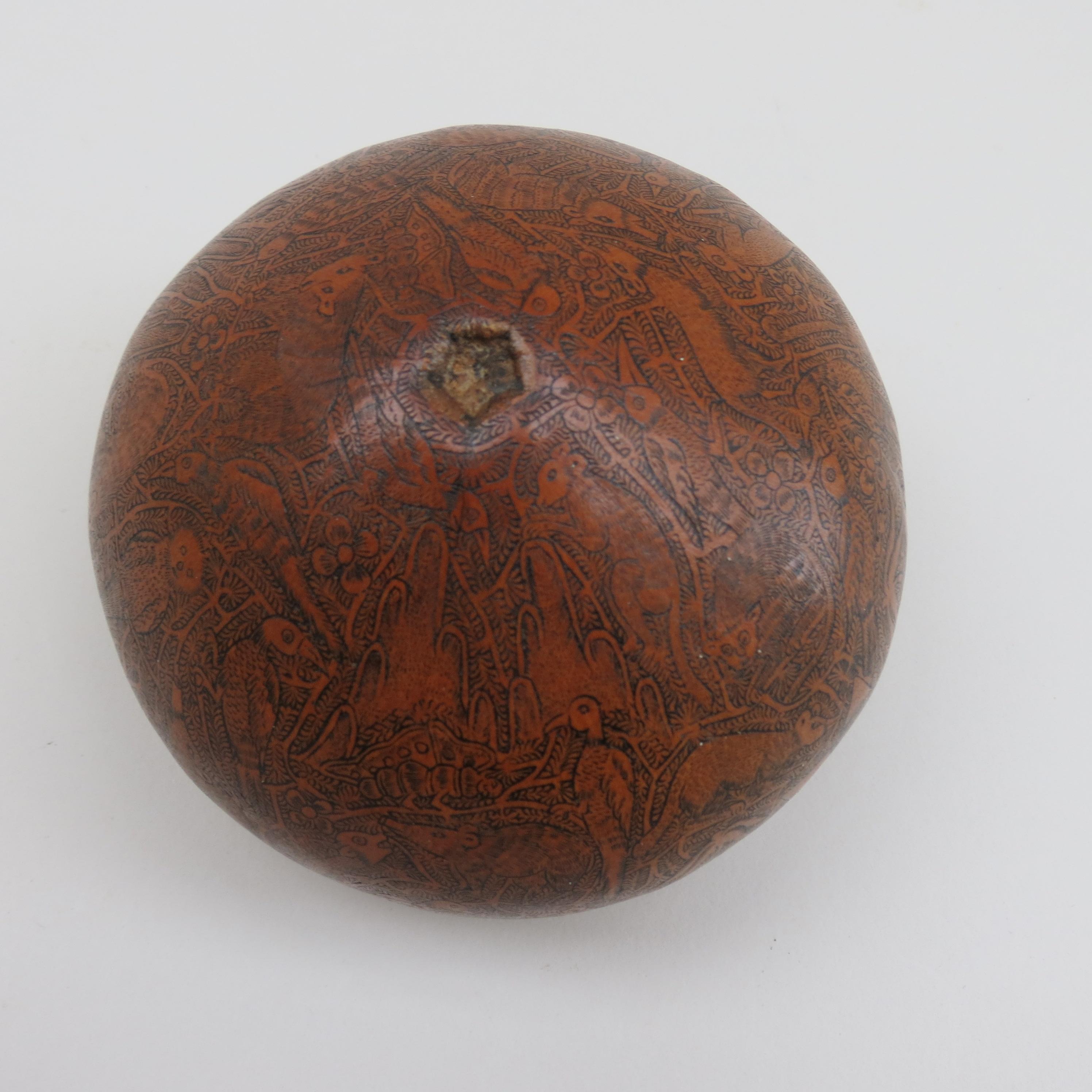Vintage hand carved Gourd from South American. Very well carved, with detailed carving showing animals and village life. The pattern flows very well around the gourd. 

In good condition. 


    