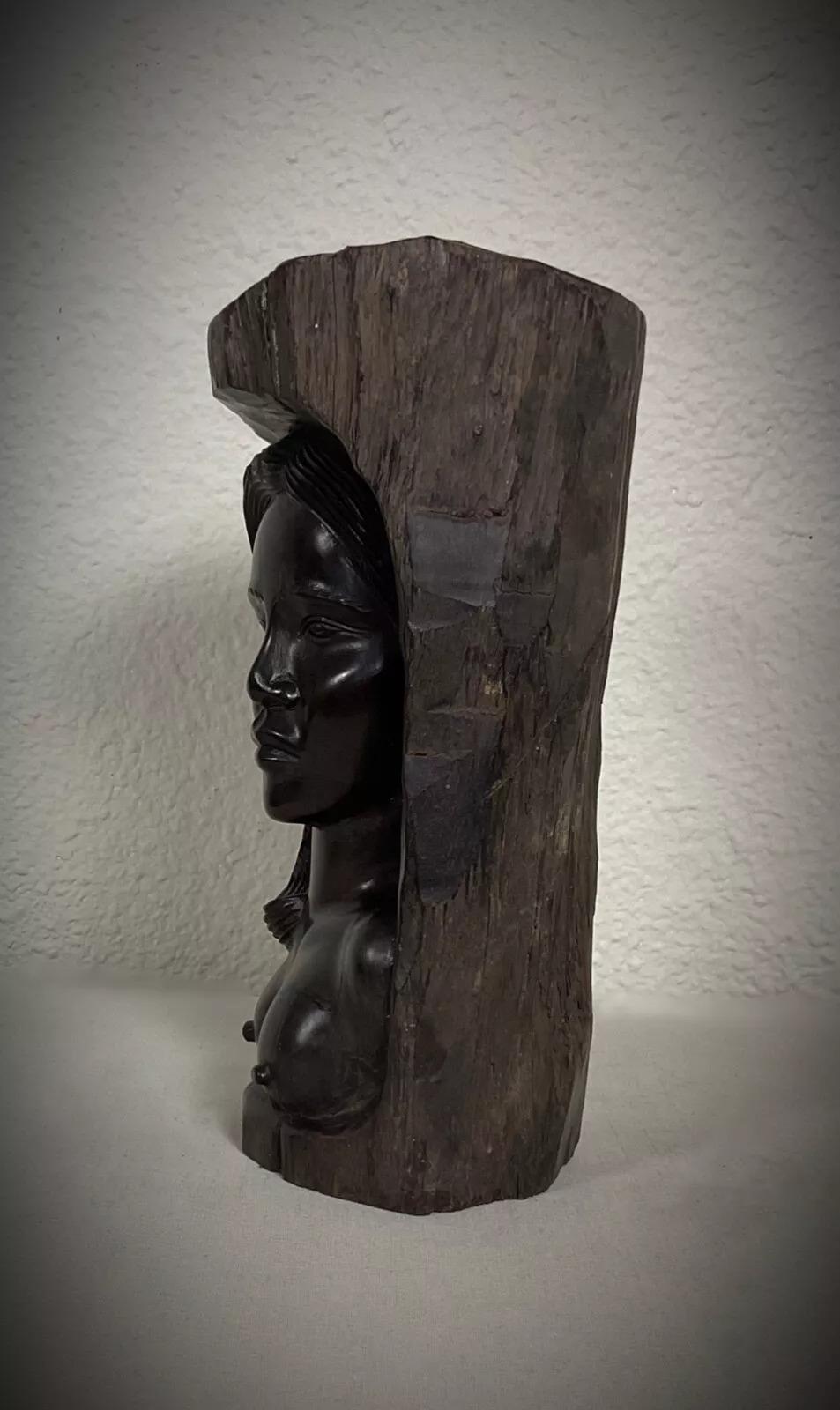 This authentic vintage Malagasy sculpture features a gracefully hand-carved nude female figure, crafted from solid ebony wood. A stunning representation of African craftsmanship, this piece originates from Madagascar and dates back to the