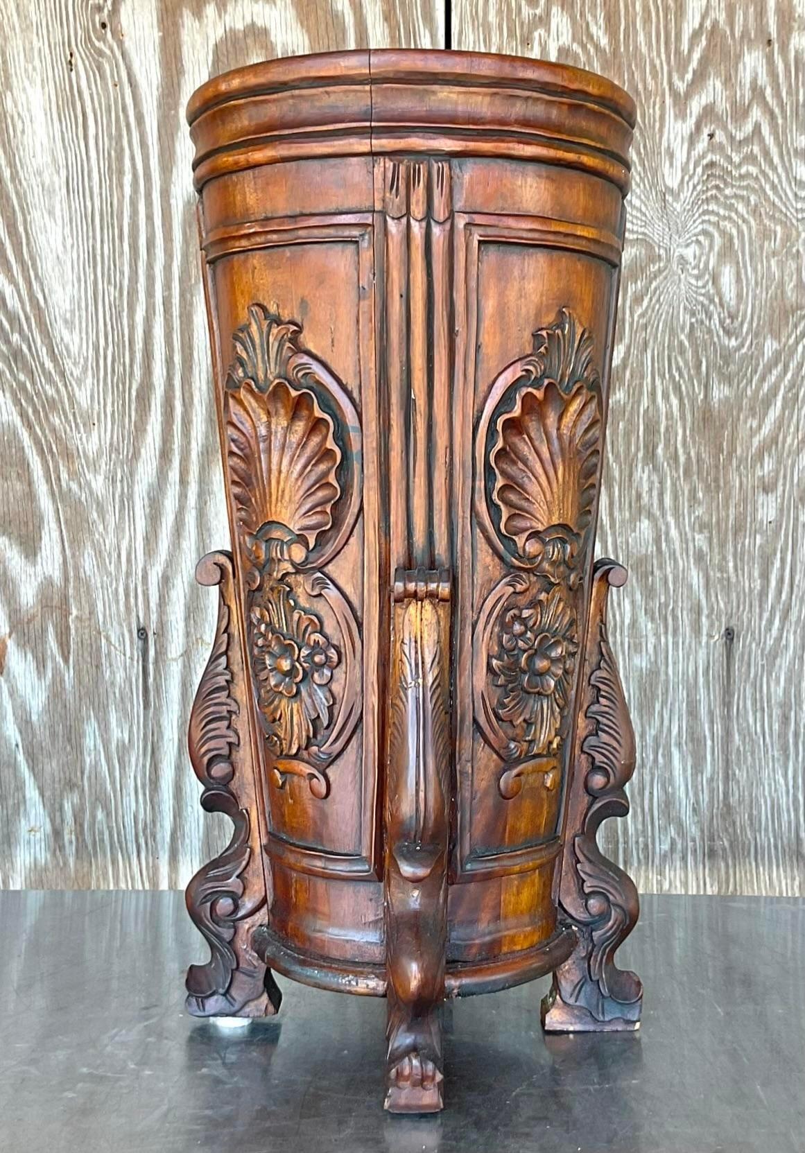 A gorgeous vintage hand carved wooden umbrella stand. The wooden umbrella stand is hand carved with attention to floral detail and it shows. Acquired at a Palm Beach estate.