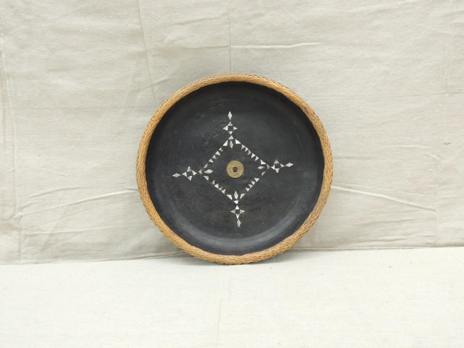 Vintage hand carved round Moroccan decorative tray or serving bowl
With inlaid mother of pearl and brass coin in the center
Inset mother of pearl round outer ring and breaded seagrass rim
Size: 11.5” D x 2.25” H.


 