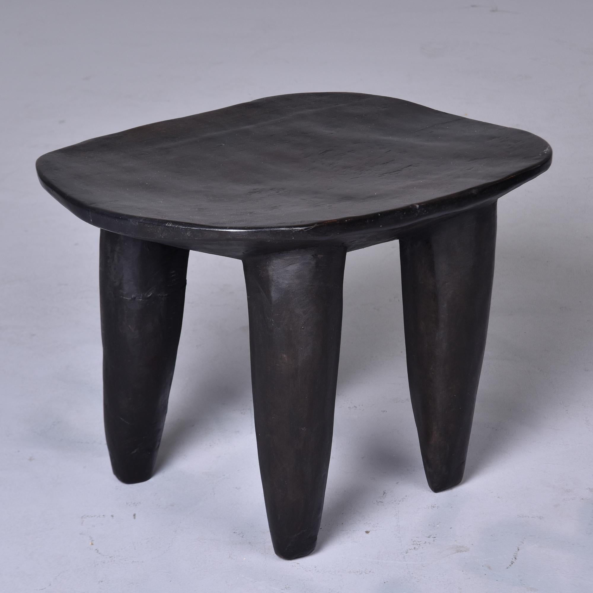 This circa 1980s stool or side table is just under 23” wide. It is hand carved from a single piece of wood with thick, tapered legs by the Senufo people of Cote d’Ivoire. Very distinct and versatile;  this can be used as a stool, ottoman or accent