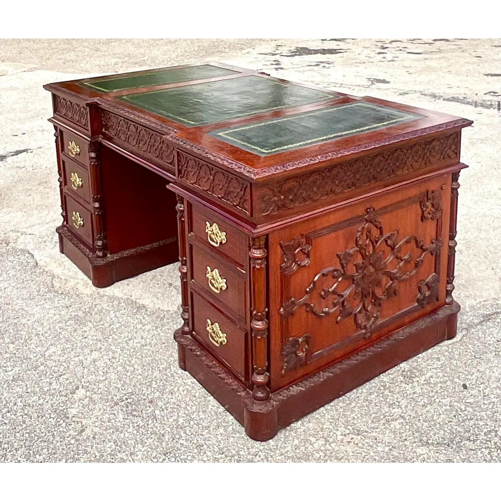 Fantastic vintage Regency Executive desk. Beautiful carved swag detail and embossed black leather top. Heavy brass hardware. Acquired from a Palm Beach estate.