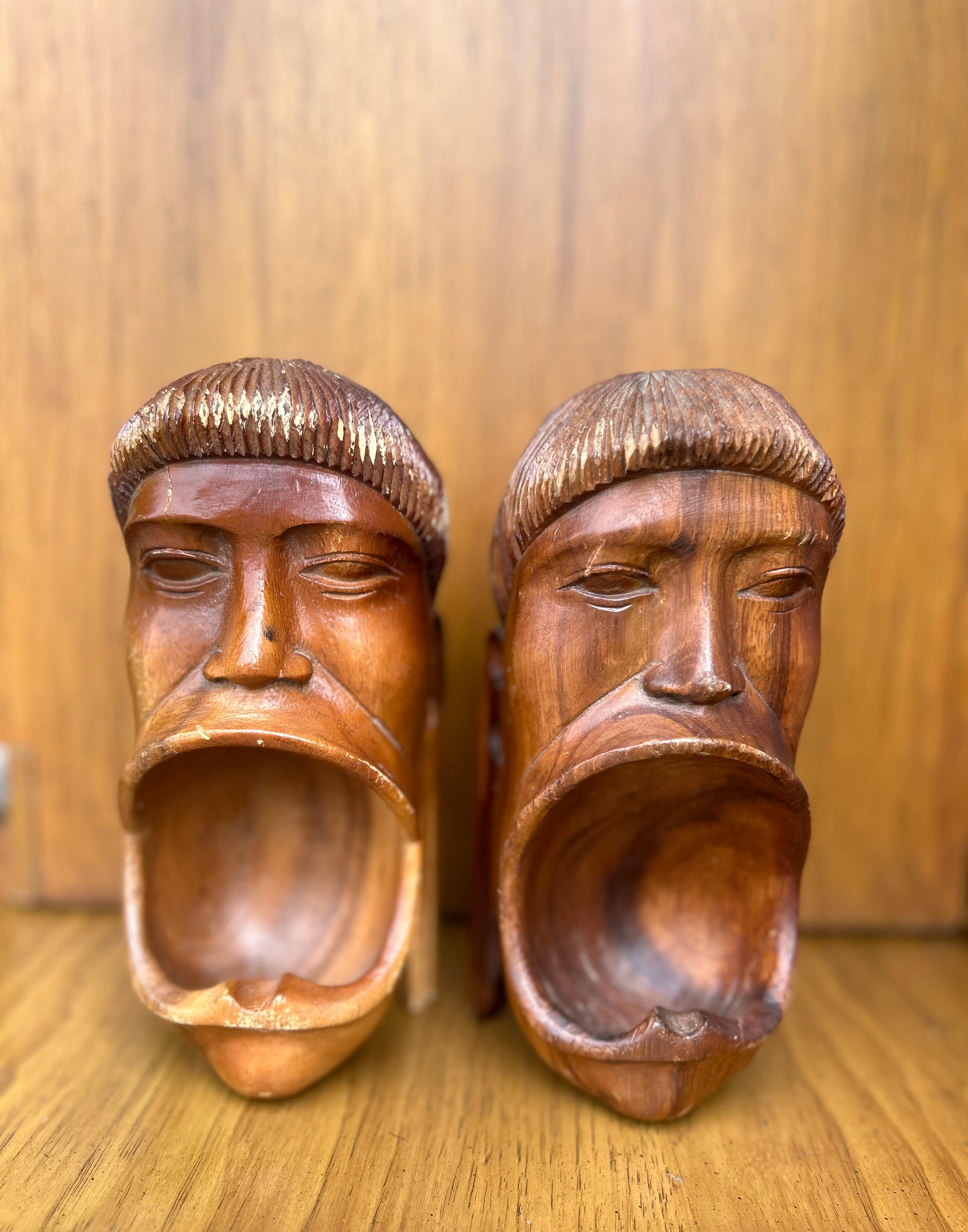 Such a unique pair of hand carved tribal faces. I have seen another individual piece listed as a vintage ash tray. The fact that this is a pair leads me to believe they are bookends. None the less, these would make beauty display pieces in any
