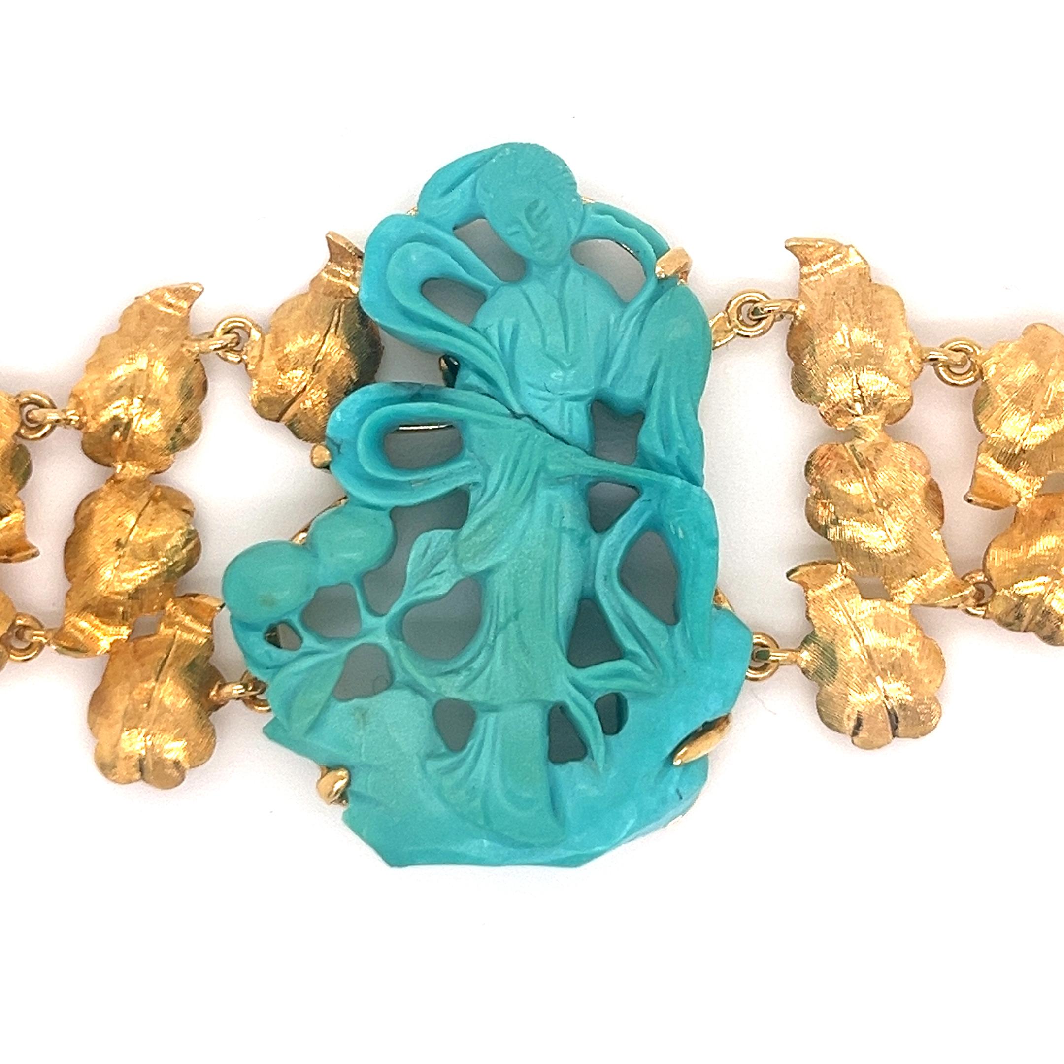 This exquisite bracelet features a stunning centerpiece of hand-carved natural turquoise depicting a classical female figure in a flowing dress or robe. The carving demonstrates exceptional artistry with its intricate openwork design, creating a