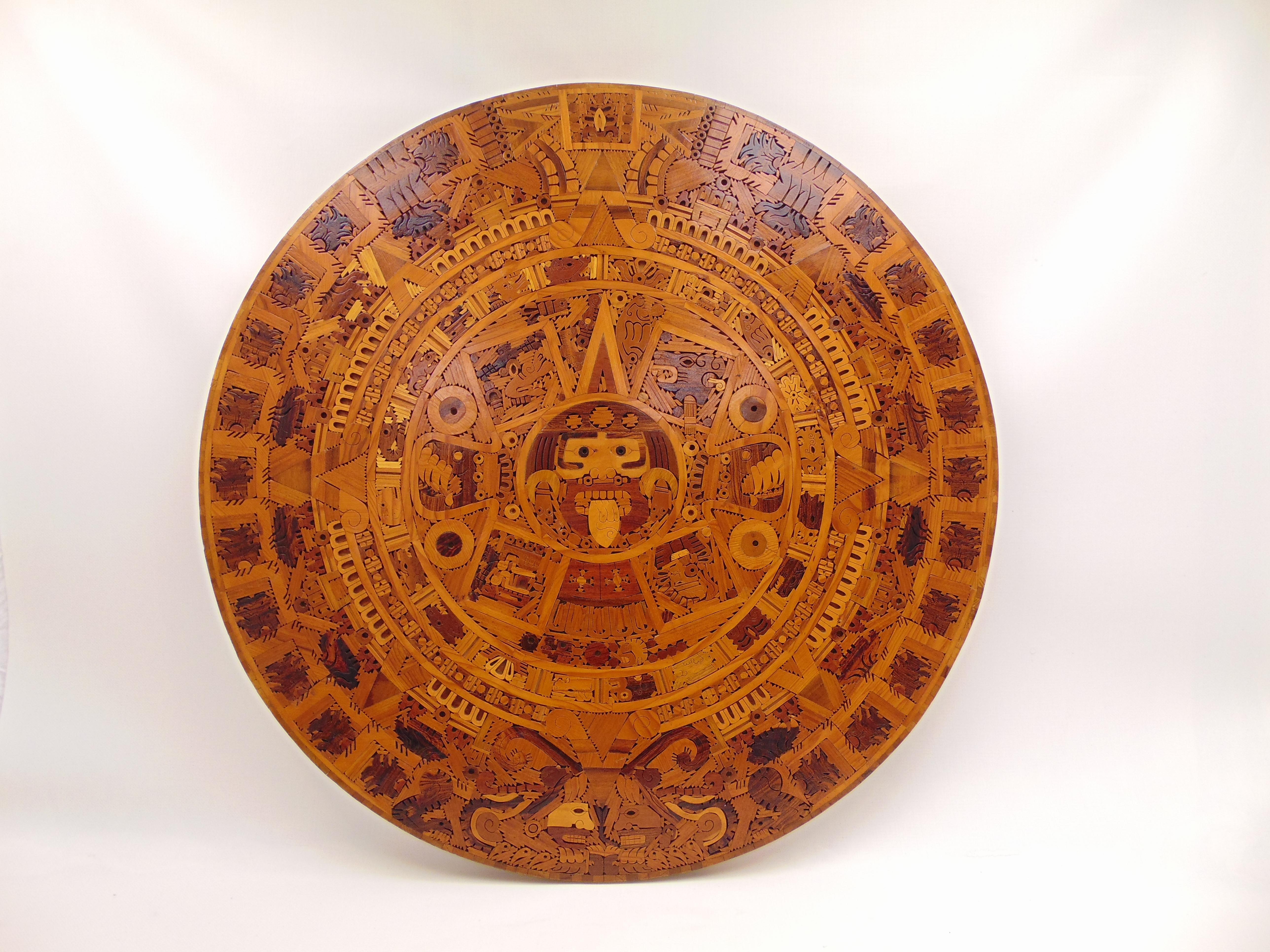 This is a beautiful example of fine wood-cutting and craftsmanship from Mexico. The calendar is called 